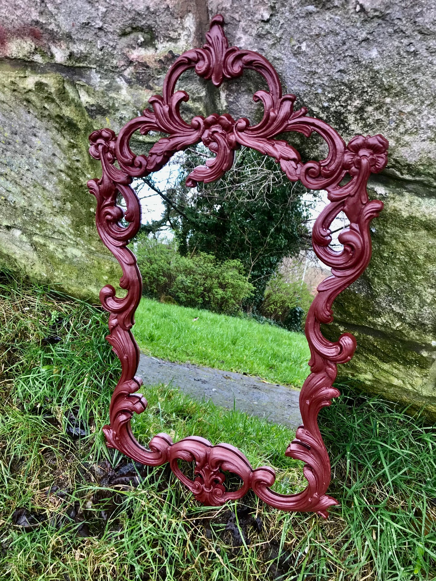 Ornate reproduction vintage plastic moulded mirror painted in a deep dark burgundy