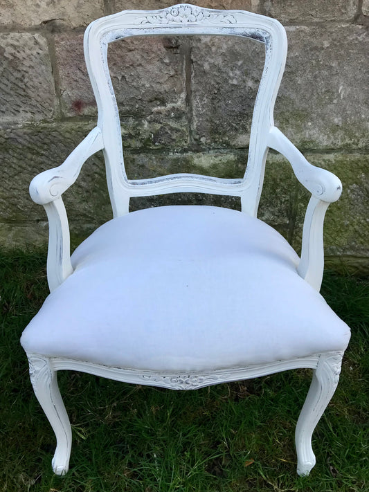 Ornate arm chair available for painting and reupholstery in a fabric of your choice.