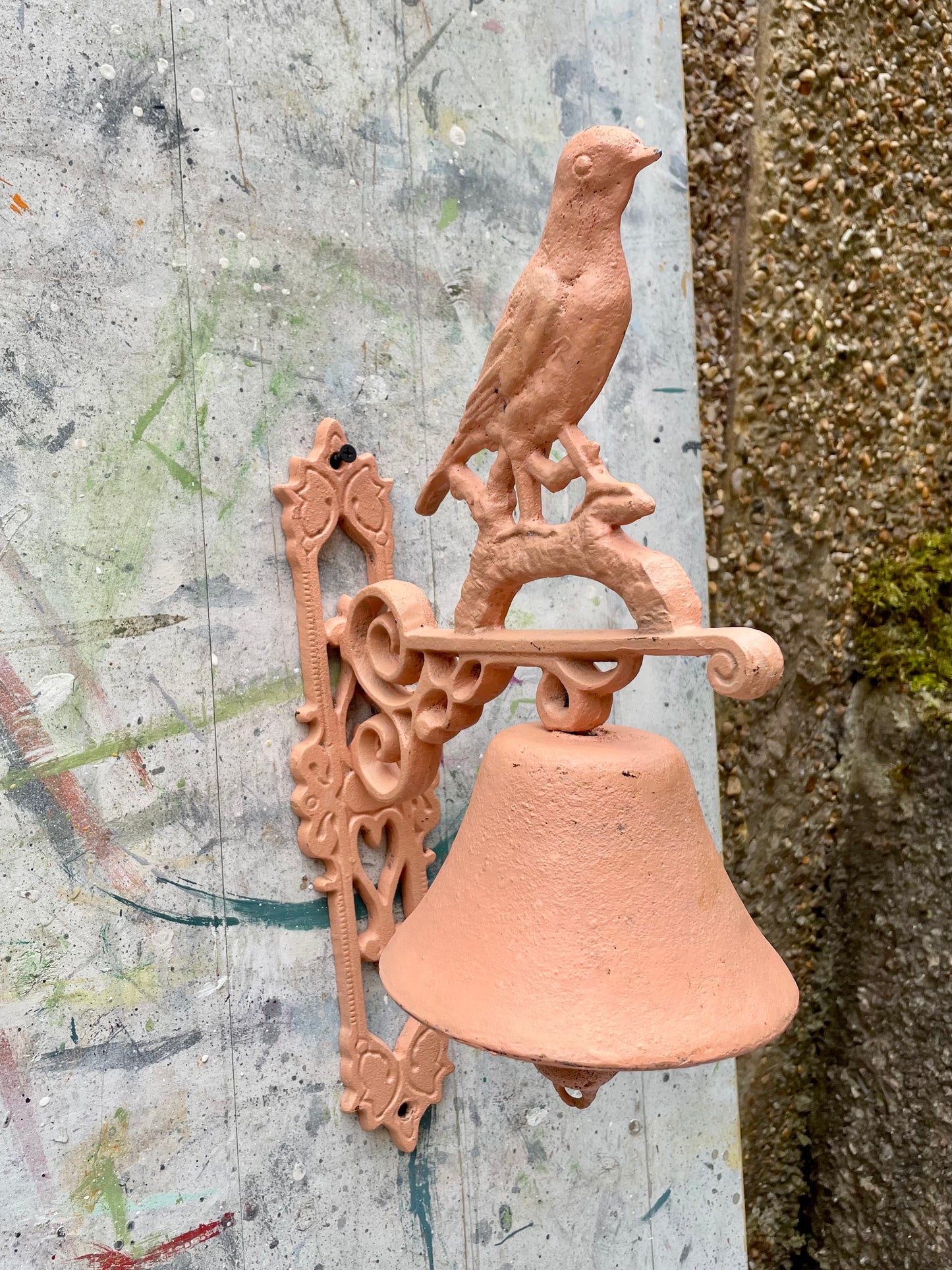 Retro painted metal bird manual door bell in peachy pink