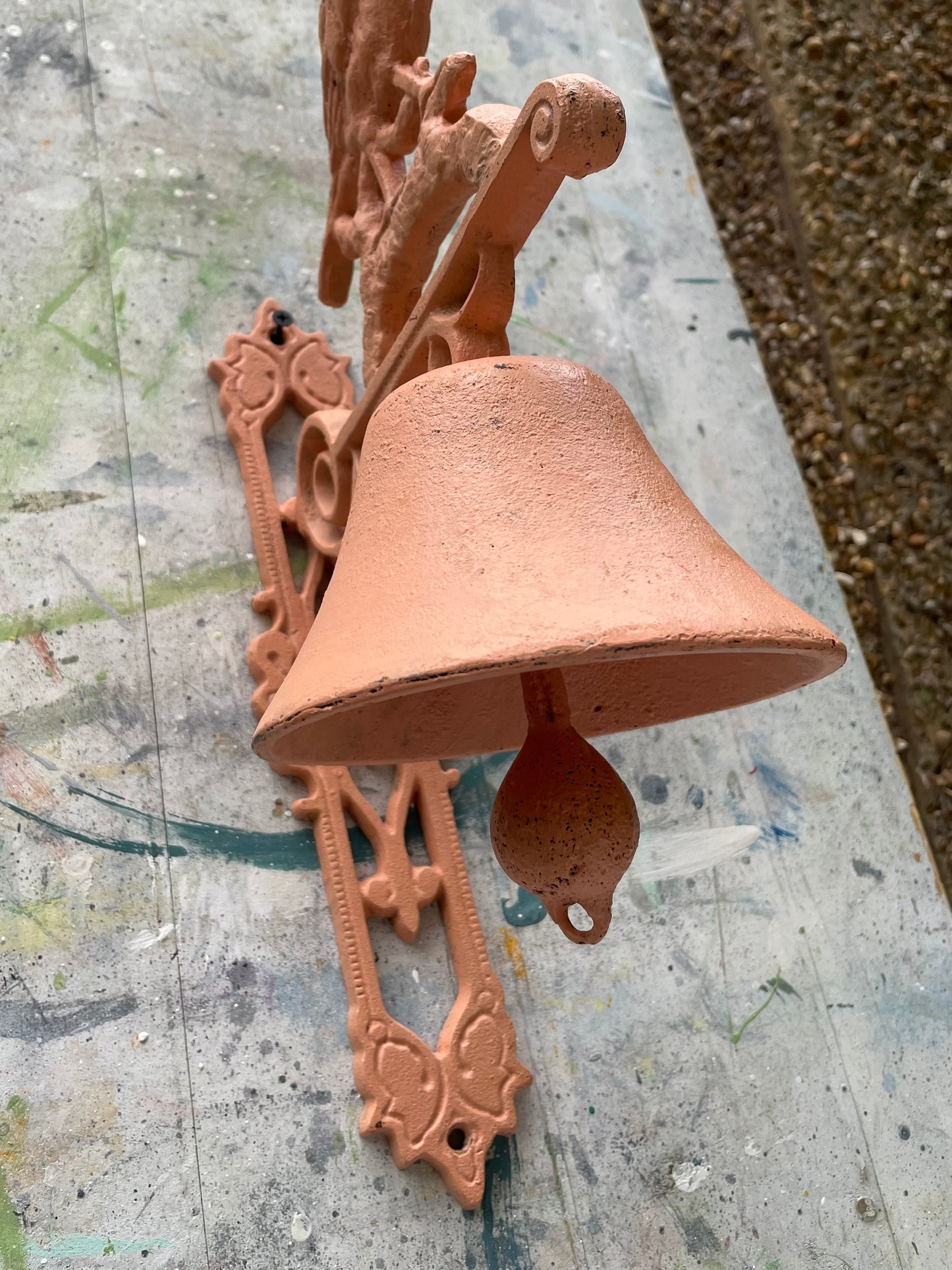 Retro painted metal bird manual door bell in peachy pink