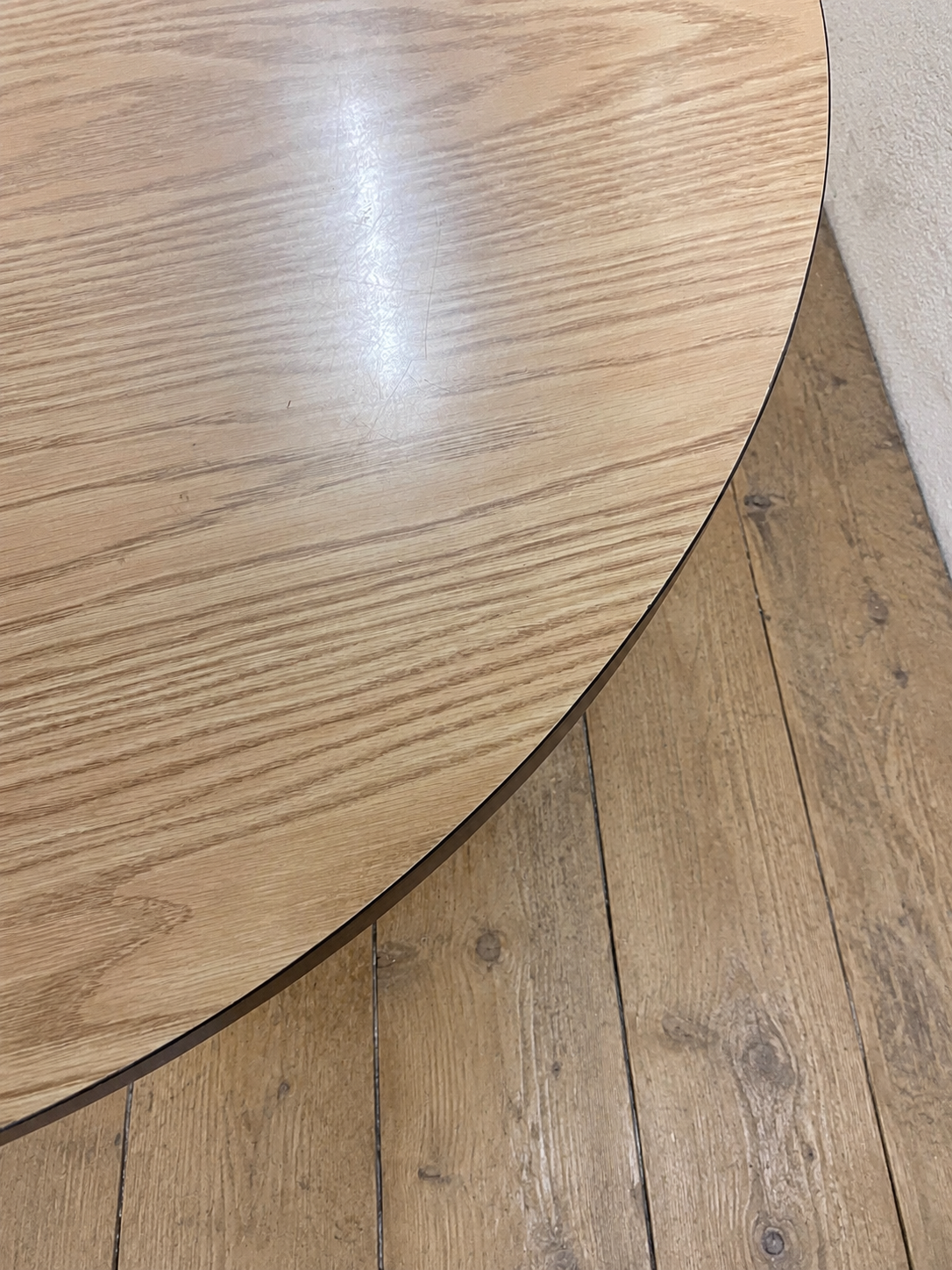 Round veneer 1980's dining table. Legs have been painted in a rust colour