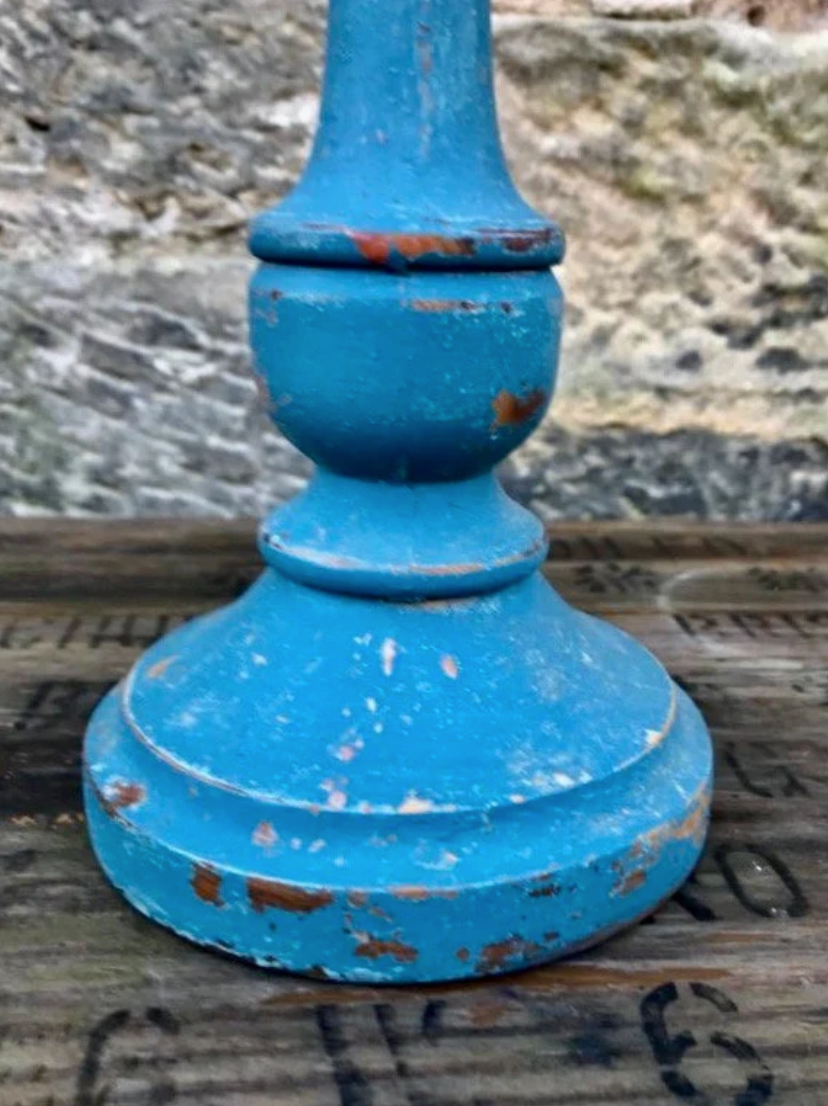 Vintage wooden candlestick painted in layers of pink and blue milk paint