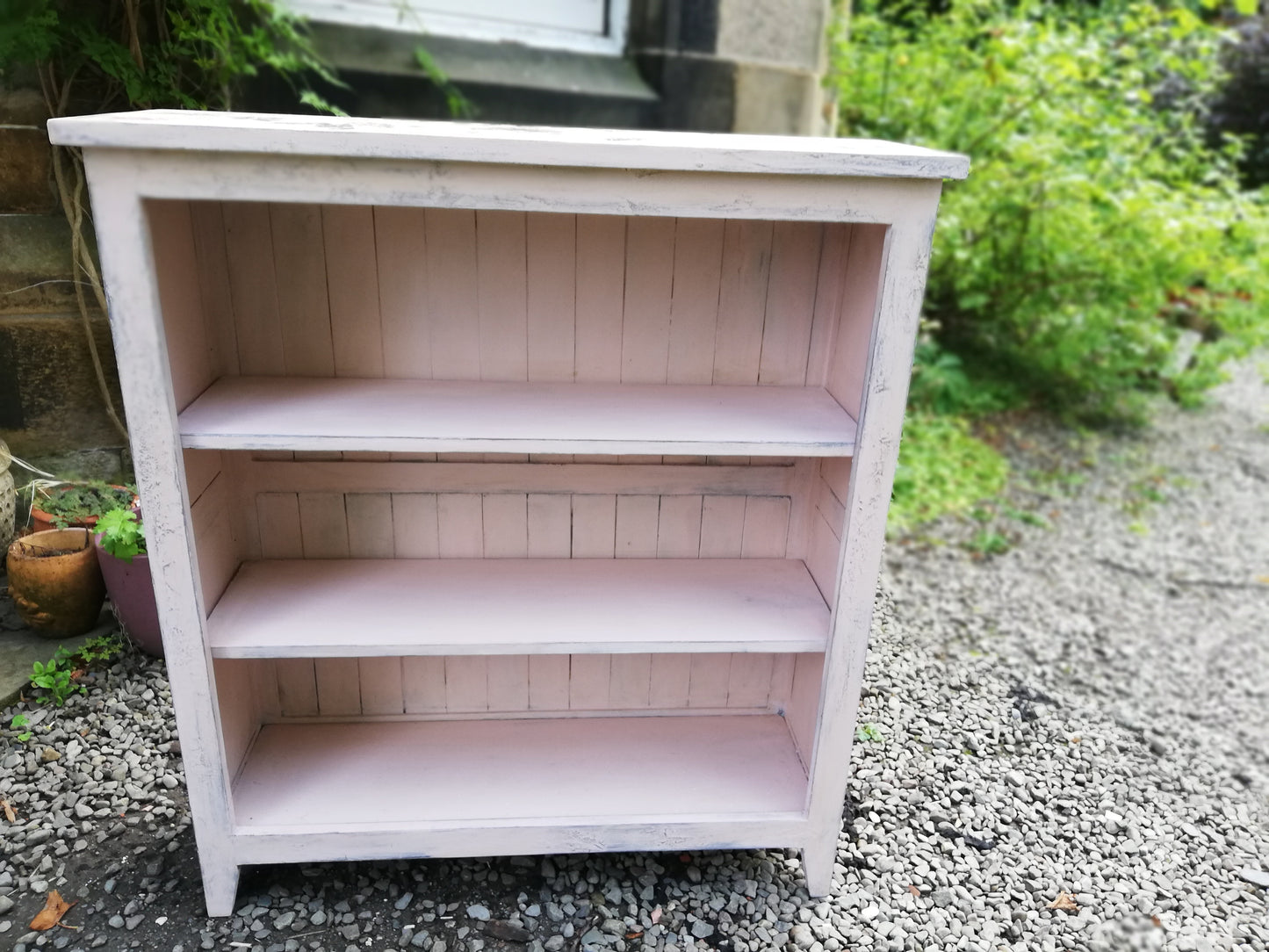 Boho pink painted bookcase with rose theme