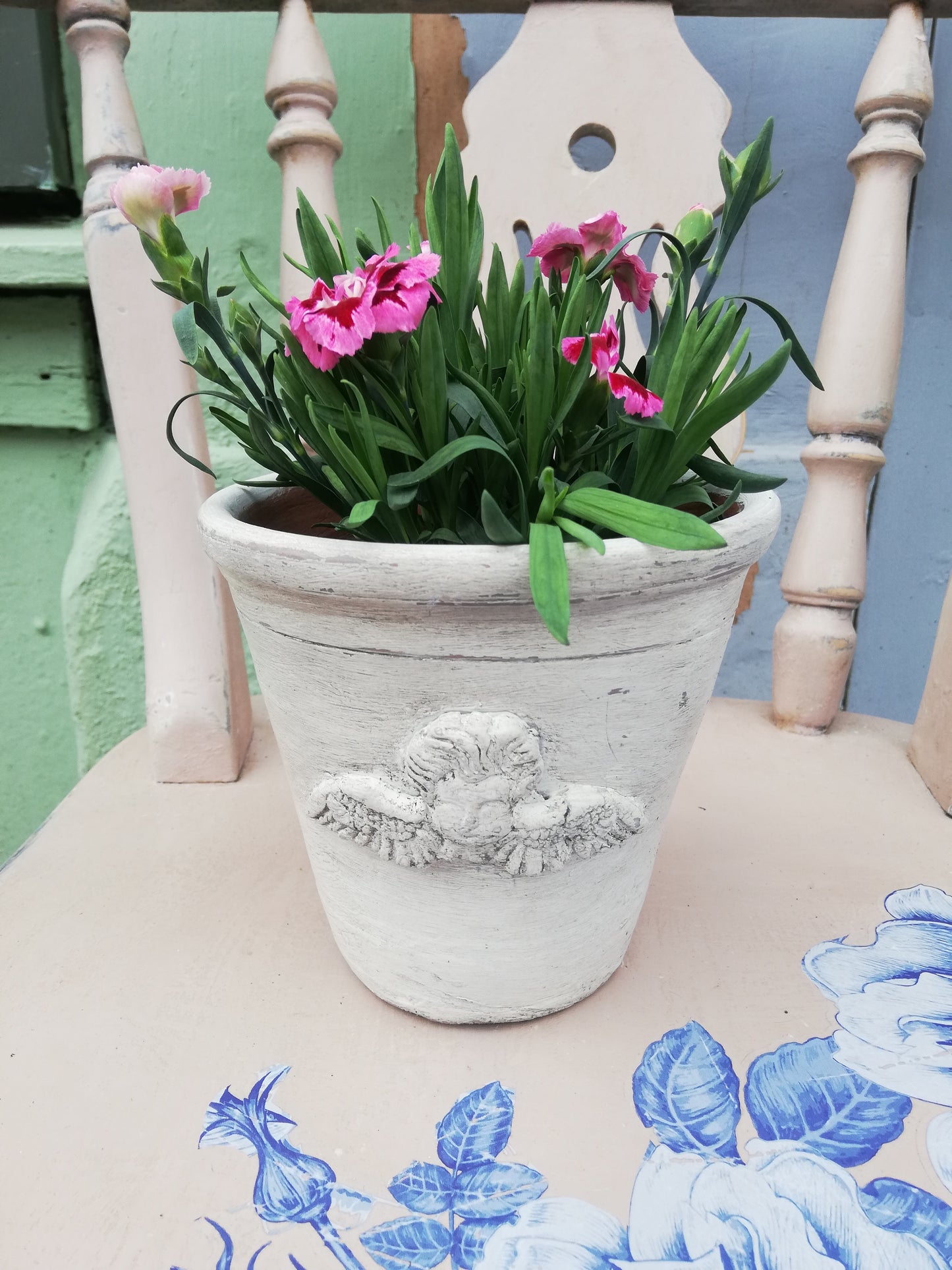 Vintage terracotta pot with cherub design
