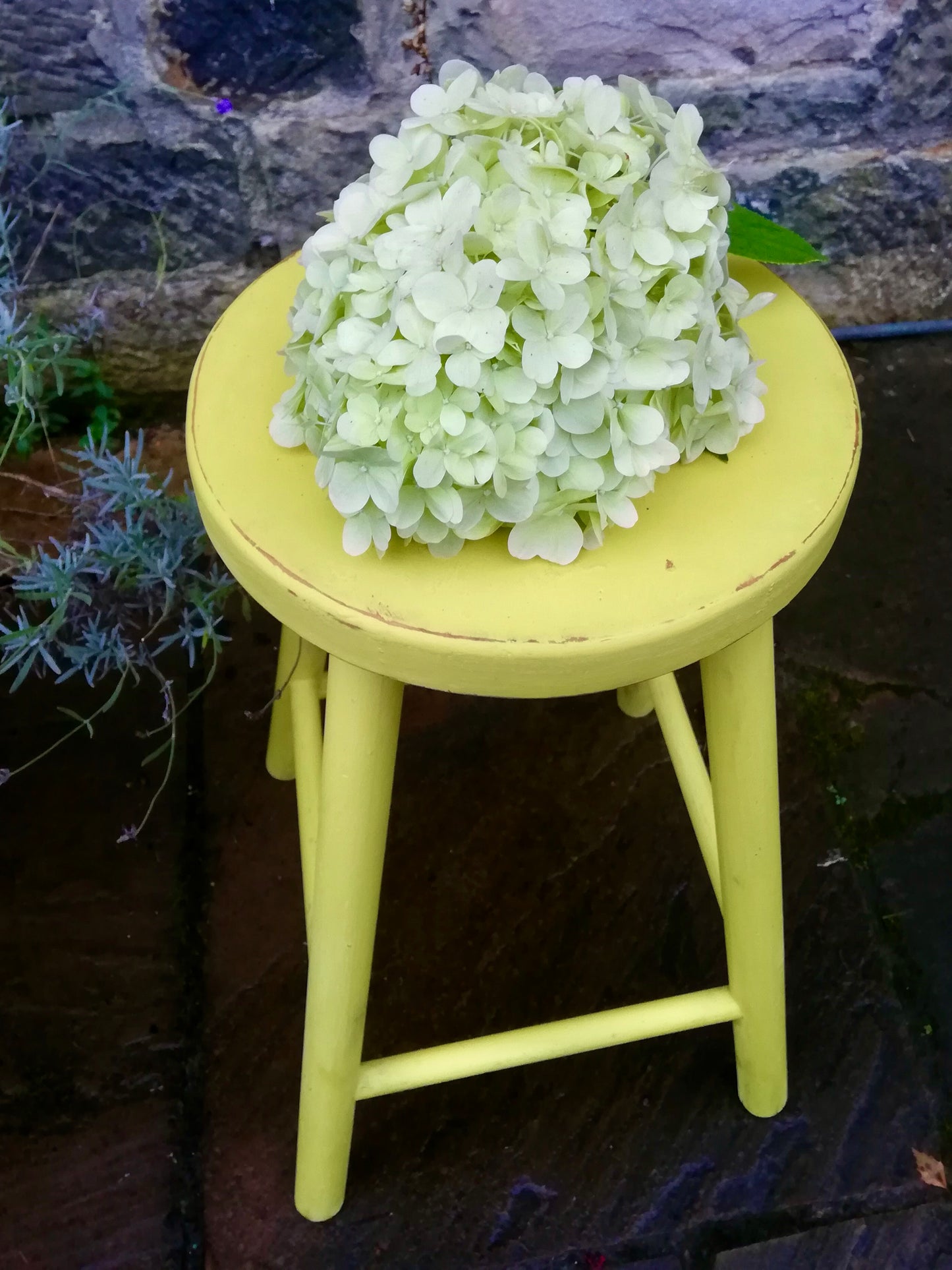 Vintage wooden stool in vibrant yellow