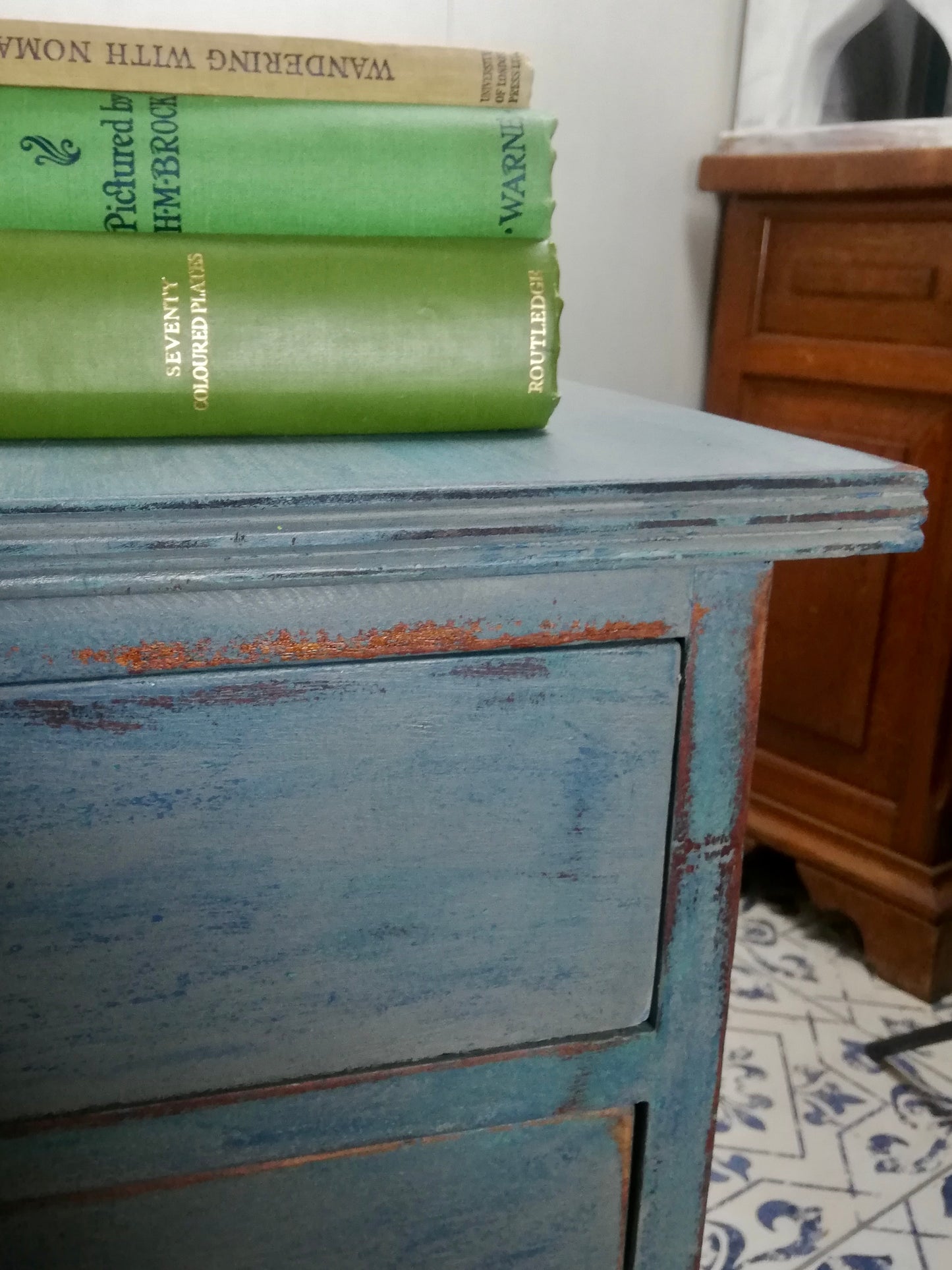 Vintage wooden filing cabinet painted in chippy layers of blue and grey.