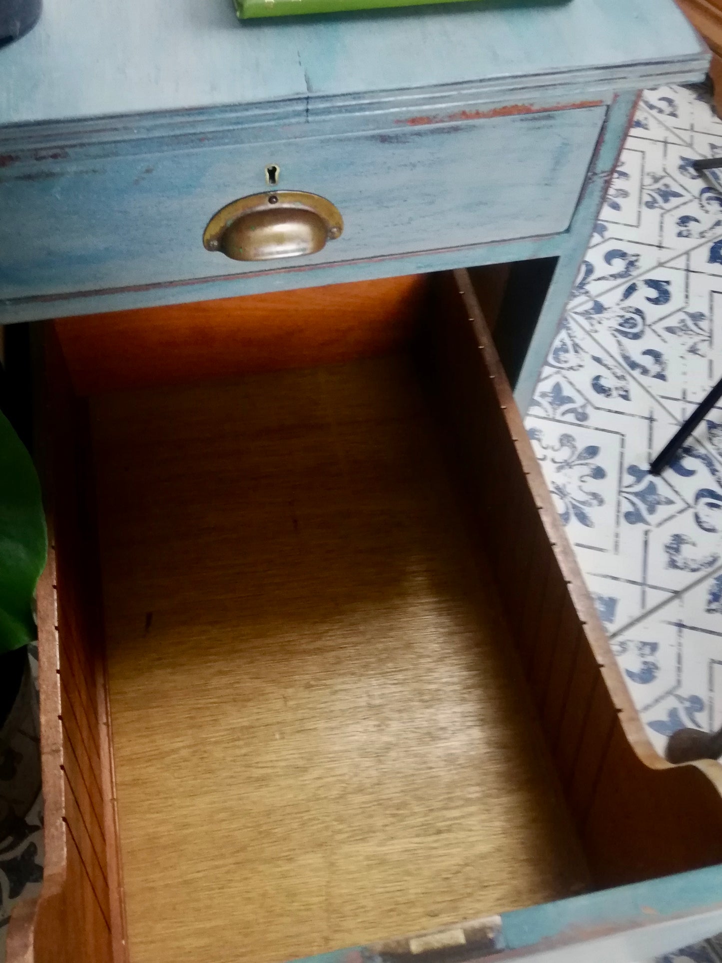 Vintage wooden filing cabinet painted in chippy layers of blue and grey.
