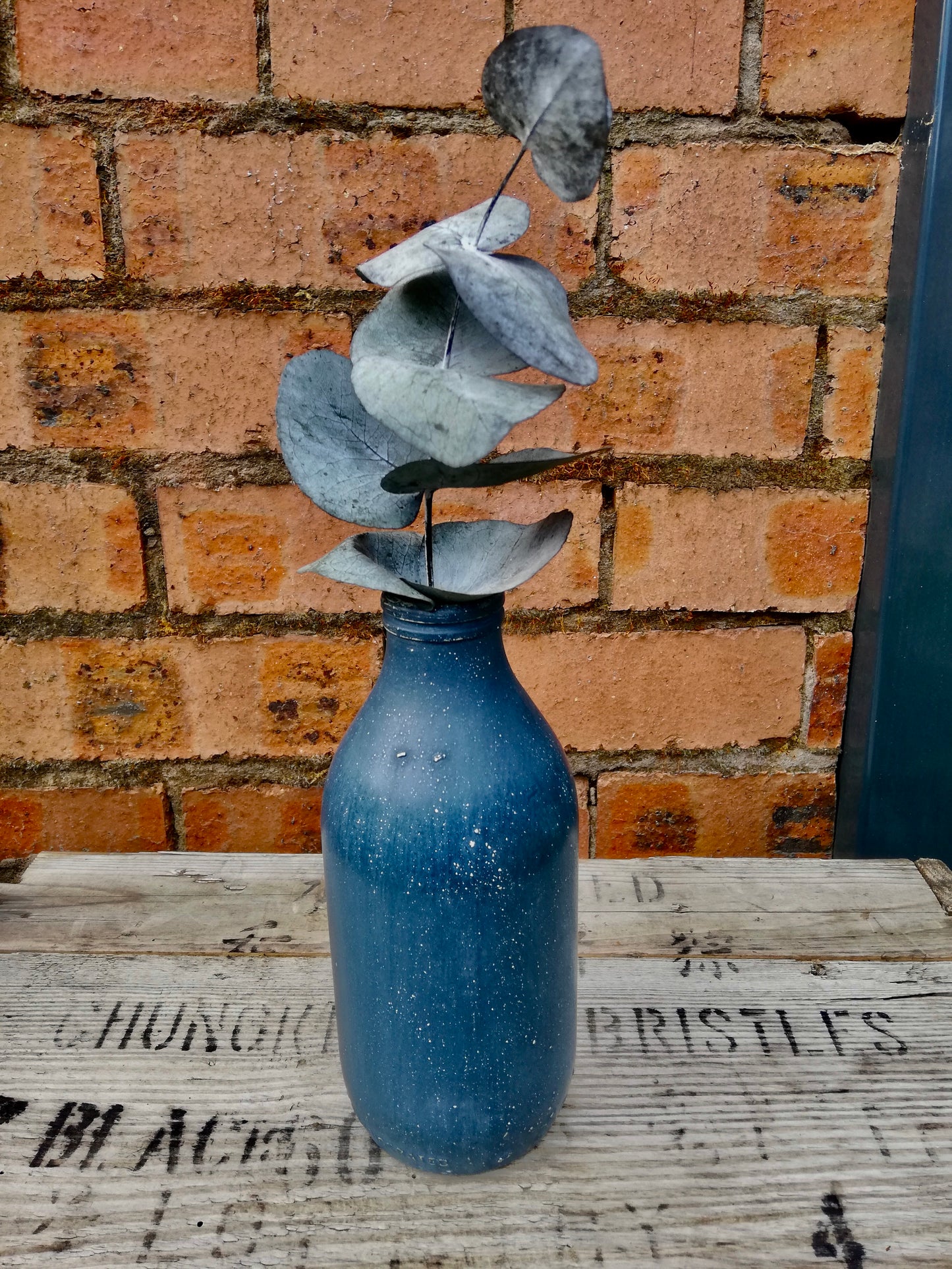 Bottle bud vase painted in layers of milk paint.