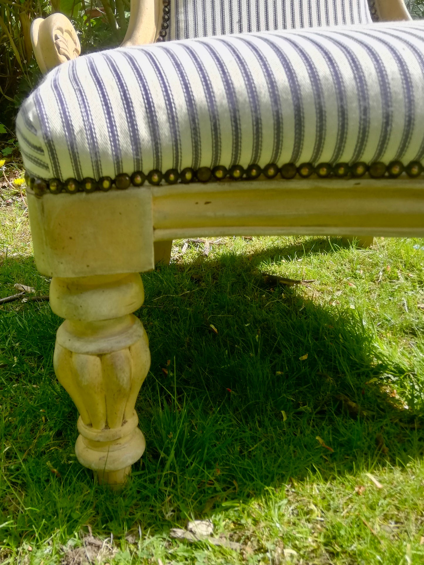 Grandmother chair painted in layers of chalk paint in grey and yellow fully reupholstered in blue ticking fabric