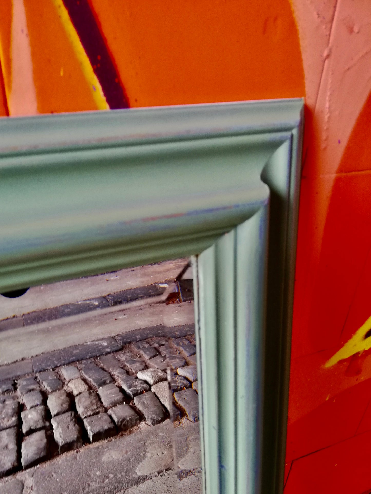 Large wall mirror painted in green and distressed for a vintage look