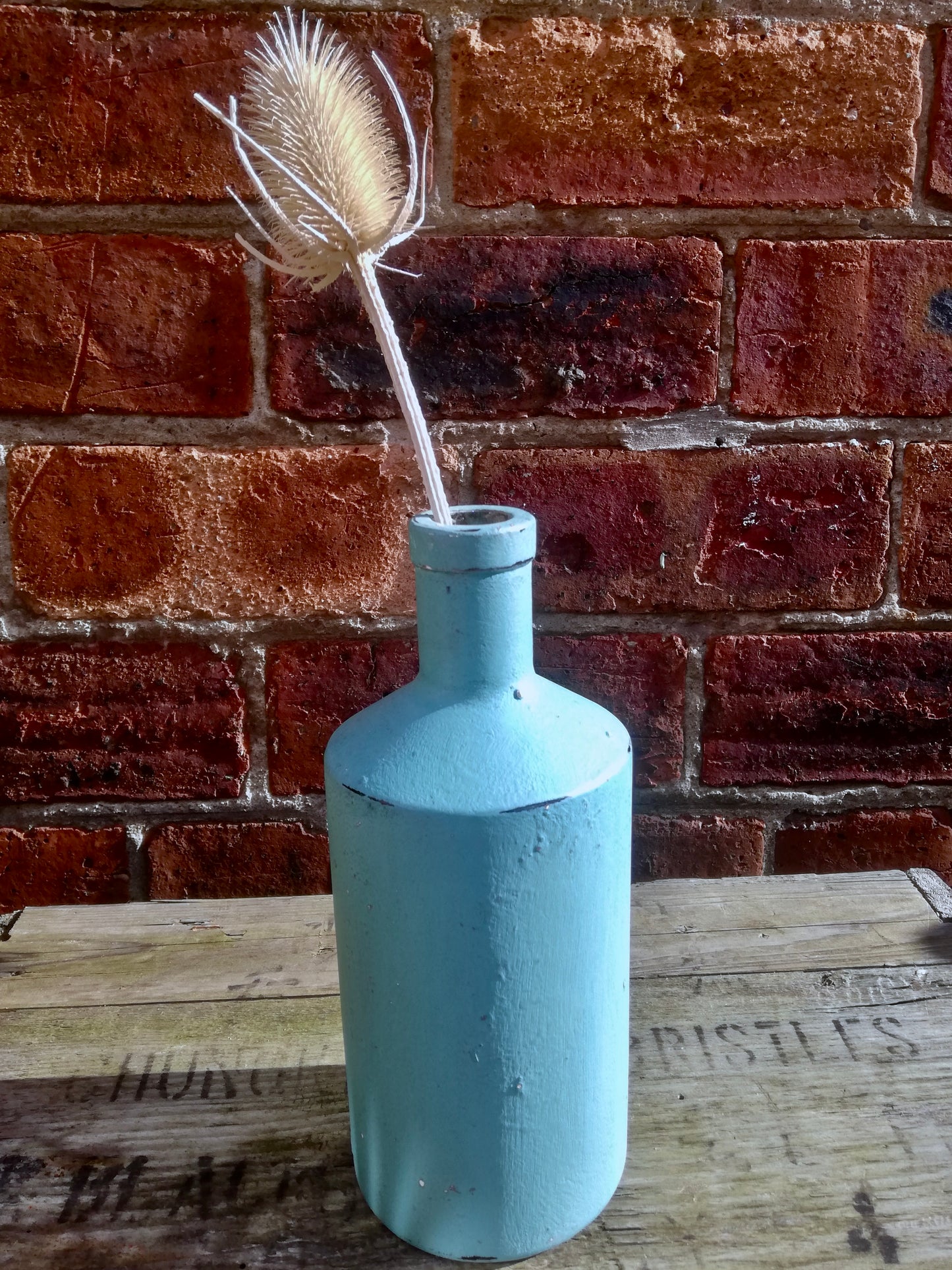 Bottle bud vase painted in textured chalk paint ad polished with wax