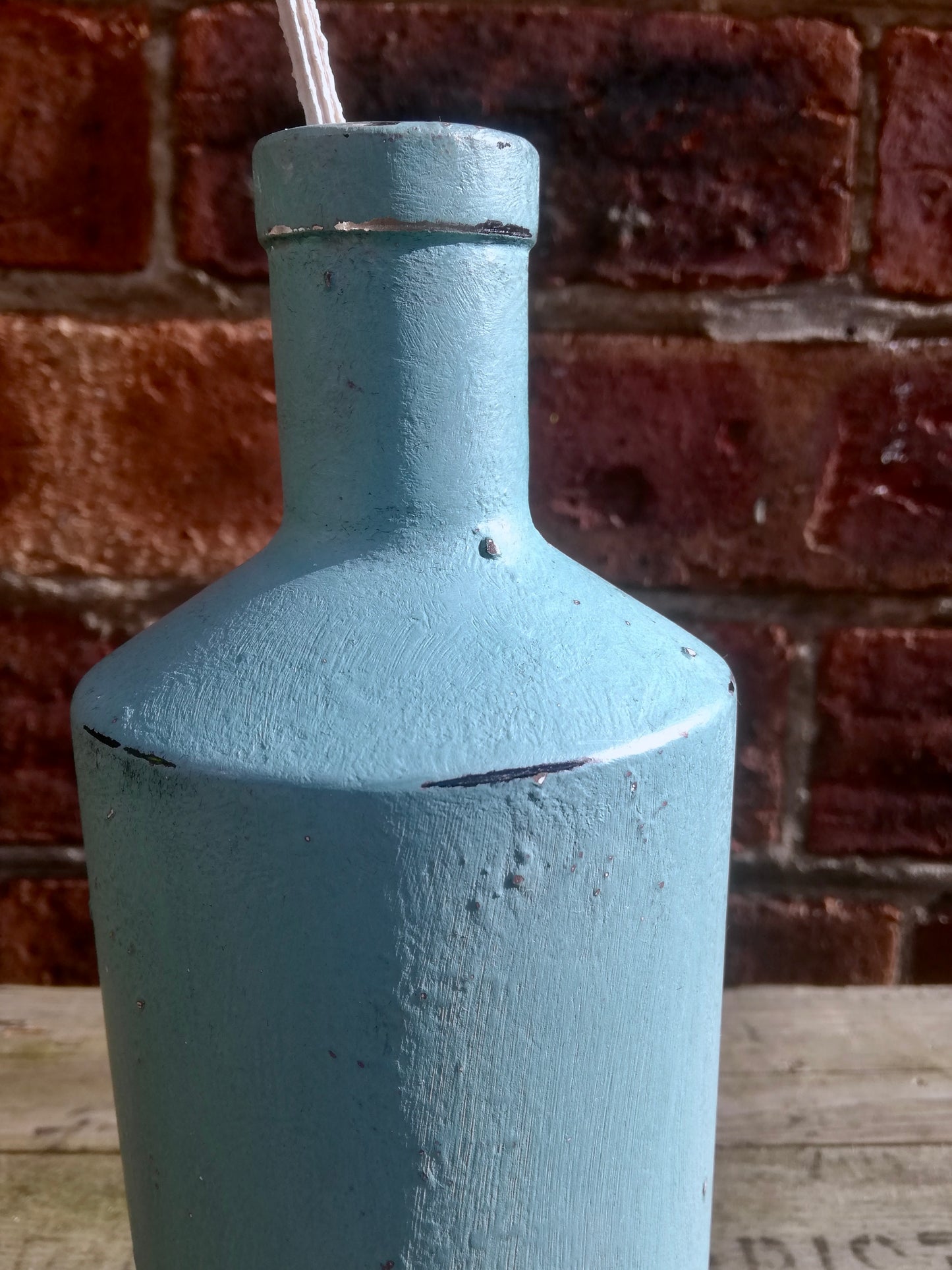Bottle bud vase painted in textured chalk paint ad polished with wax