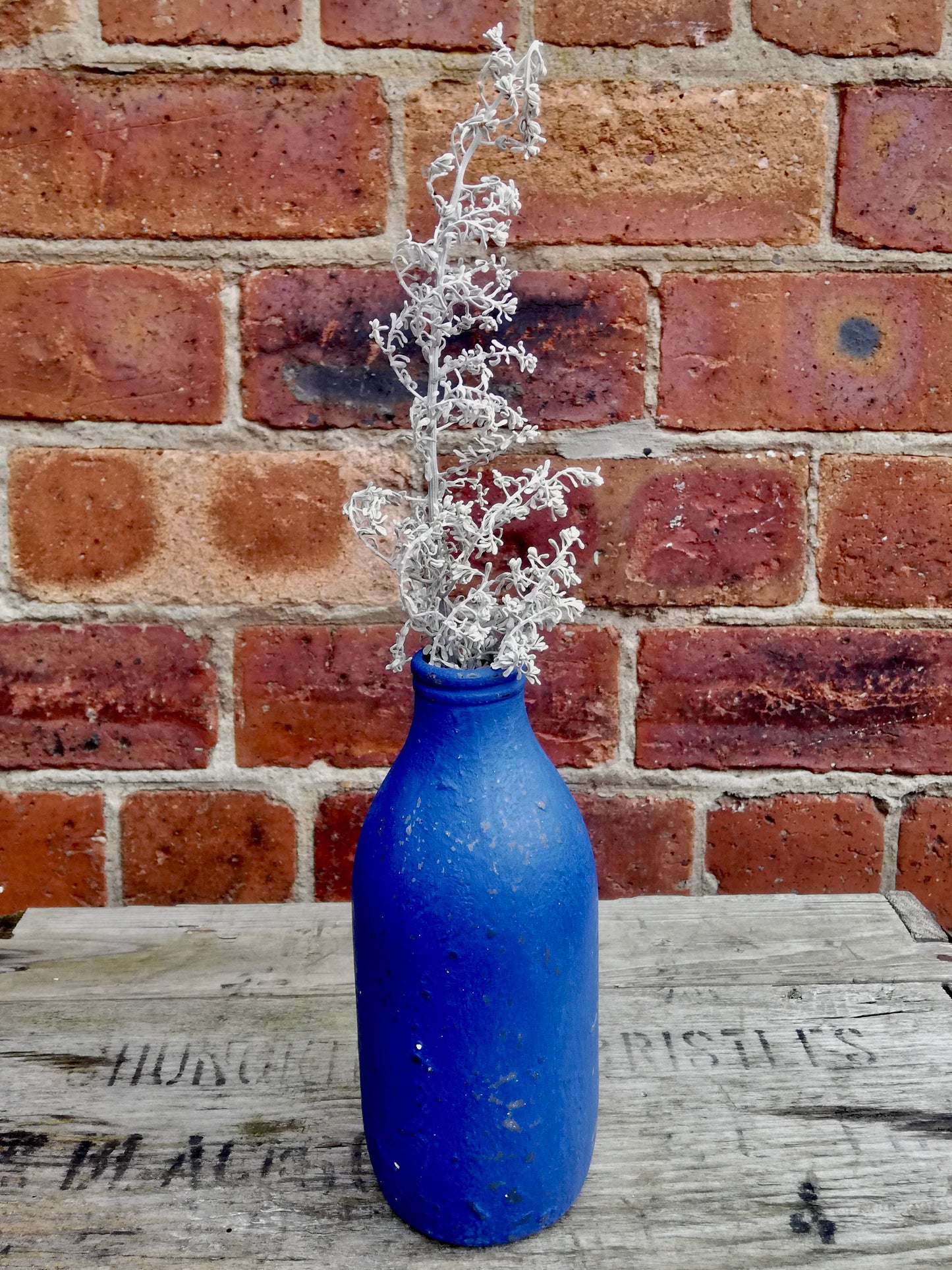 Bottle bud vase painted in layers of salt wash and chalk paint in napoleonic blue