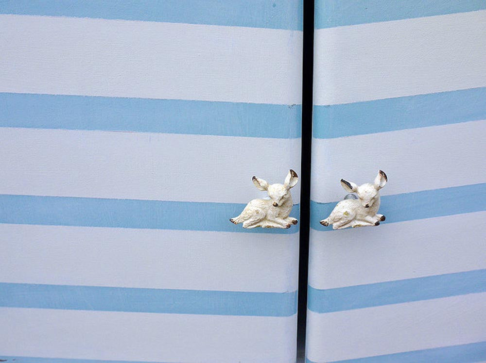 Vintage hand painted chevron record cabinet with retro deer handles.