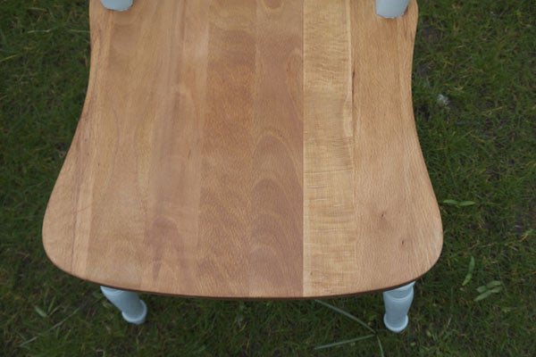 dining chairs in mismatch colours and stripped wooden seats
