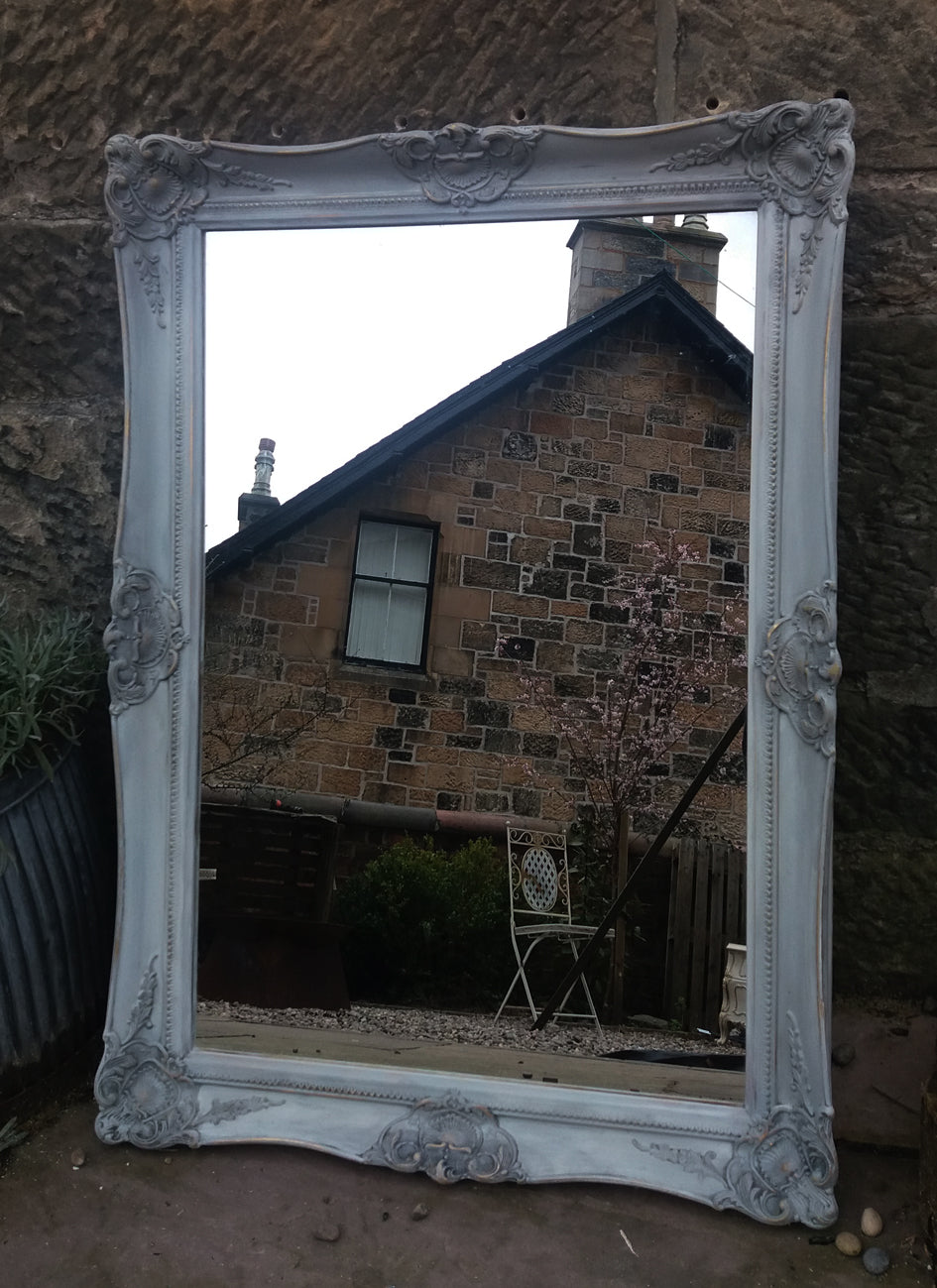Beautiful vintage ornate mirror painted in a French grey and dark waxed with original gold showing through..