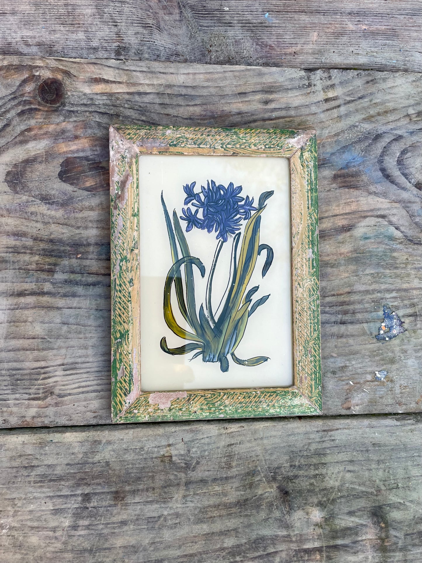 Vintage glass painting of an agapanthus flower in a beautiful original frame