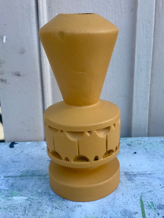 Wooden candlestick painted in mustard