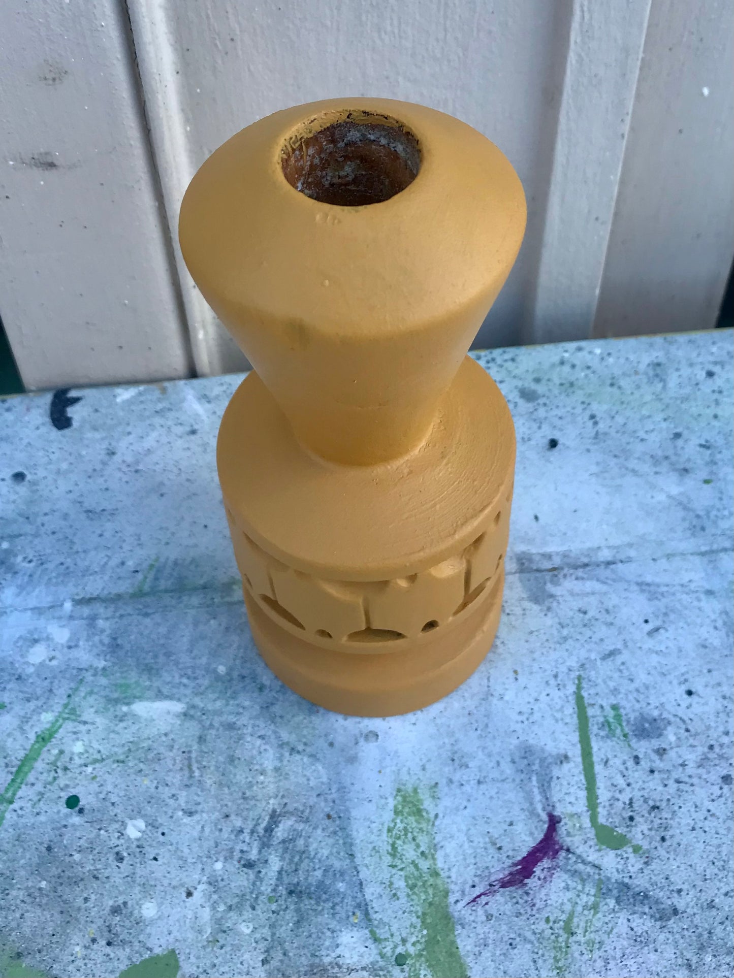 Wooden candlestick painted in mustard