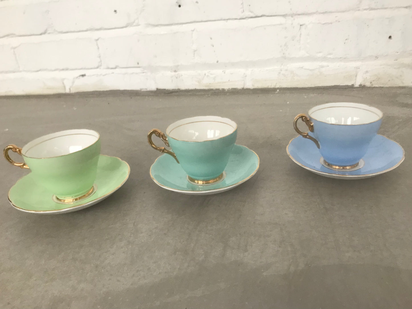 Vintage pastel and white teacups and matching sideplates