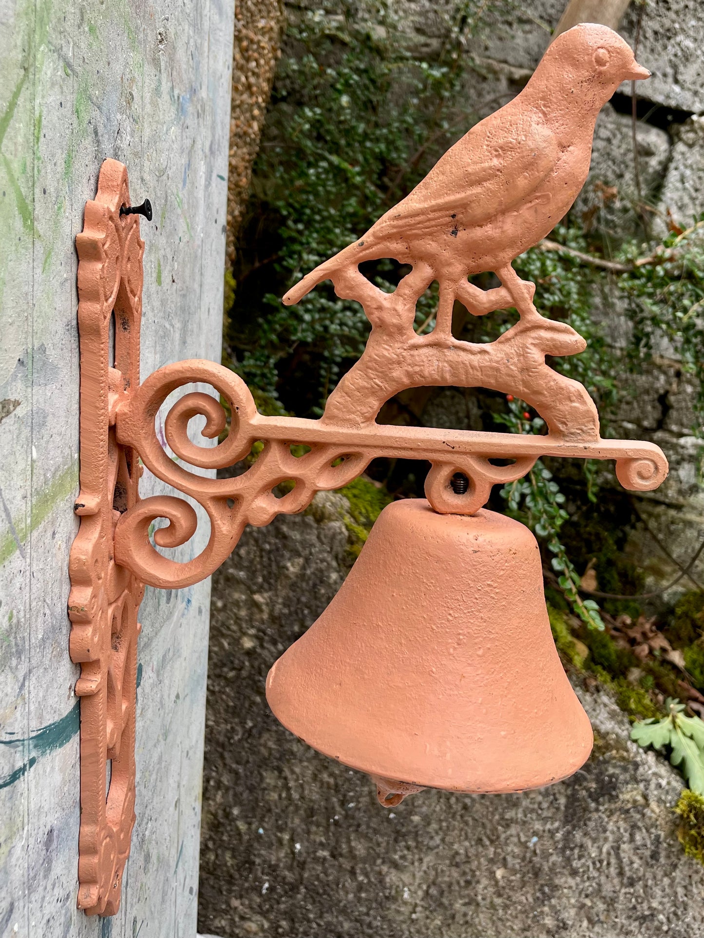 Retro painted metal bird manual door bell in peachy pink