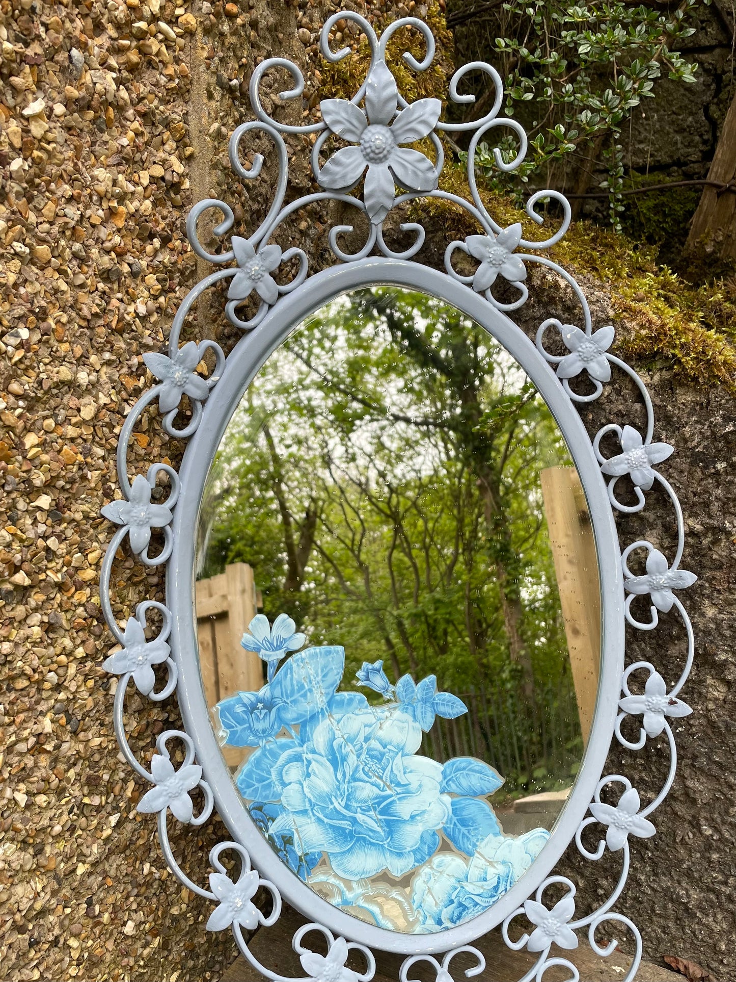 Ornate  vintage metal  mirror painted in a soft blue with floral decal