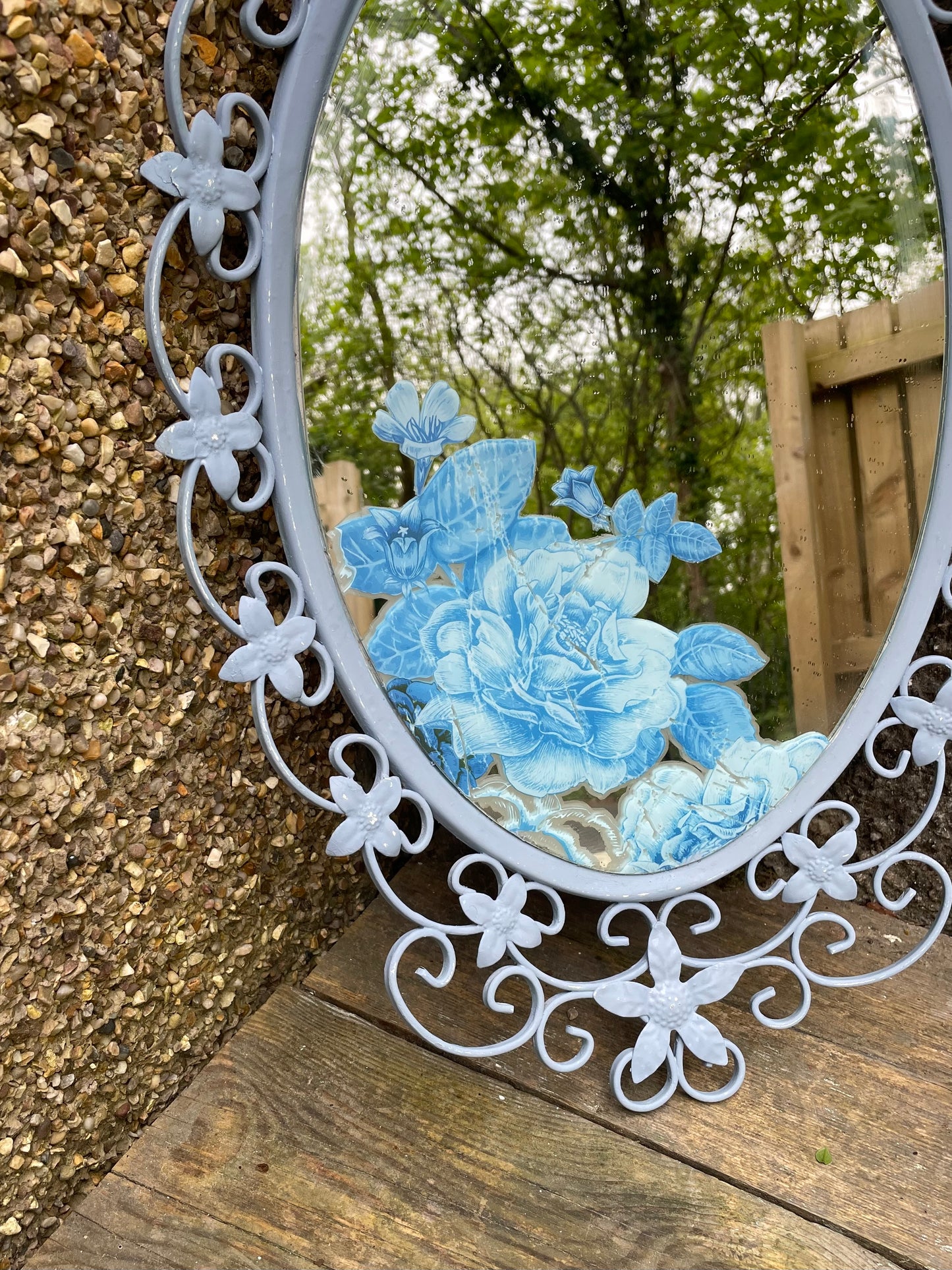 Ornate  vintage metal  mirror painted in a soft blue with floral decal