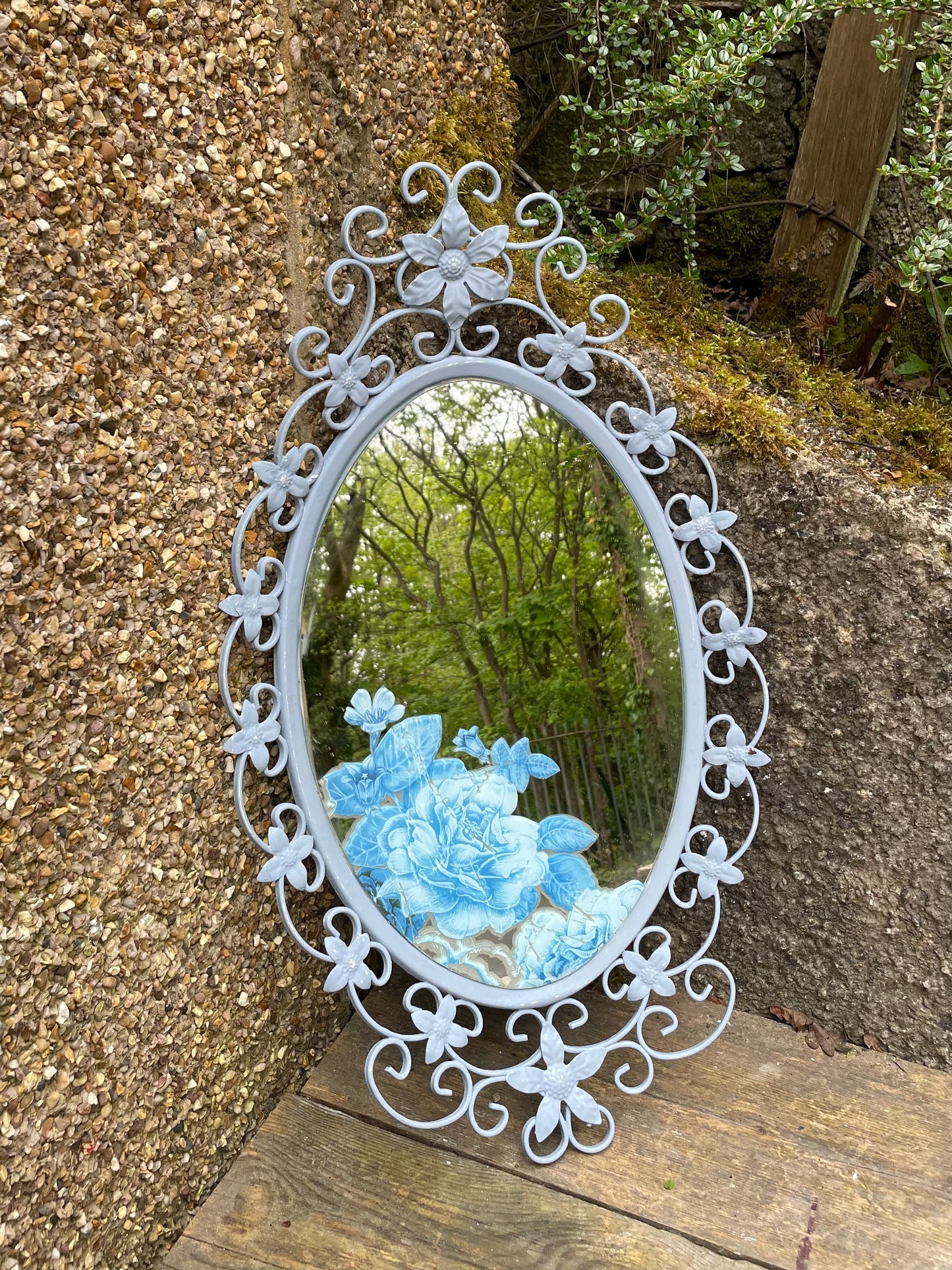 Ornate  vintage metal  mirror painted in a soft blue with floral decal