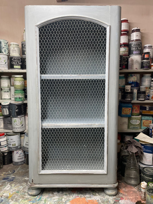 Vintage chicken wire cabinet painted in layers of traditional milk paint
