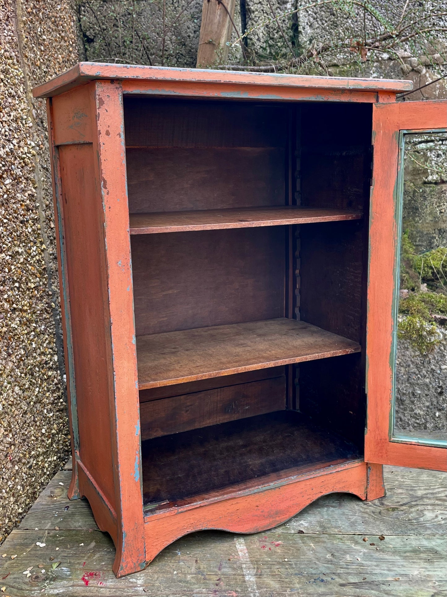 Vintage glass fronted cabinet painted in layers of traditional milk paint
