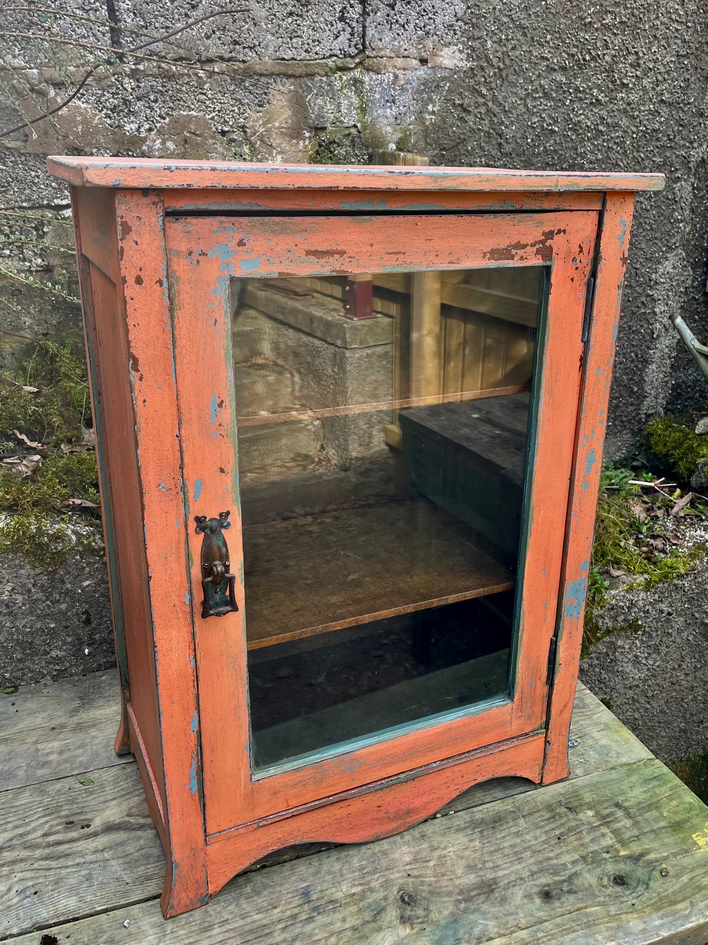 Vintage glass fronted cabinet painted in layers of traditional milk paint