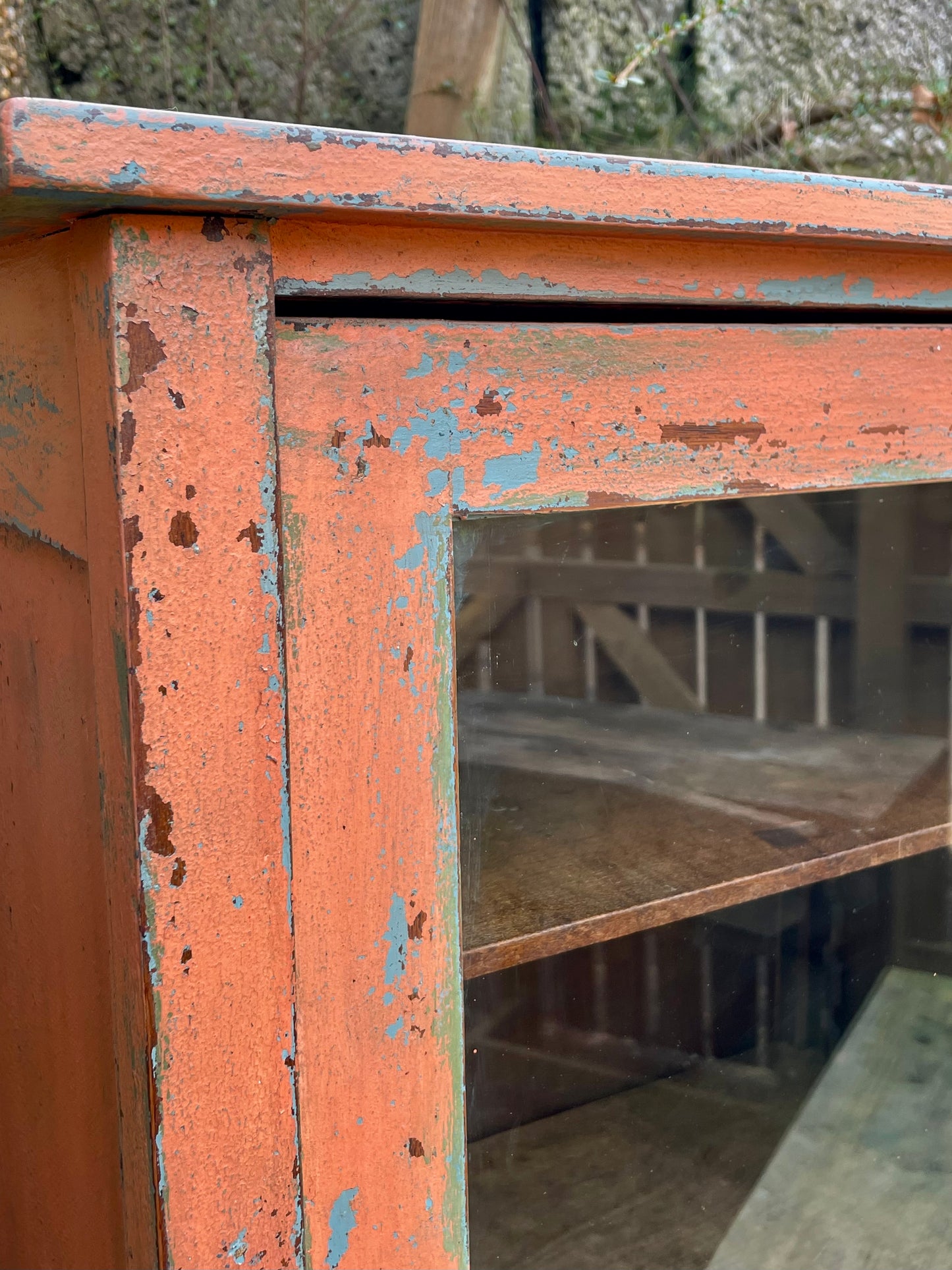 Vintage glass fronted cabinet painted in layers of traditional milk paint