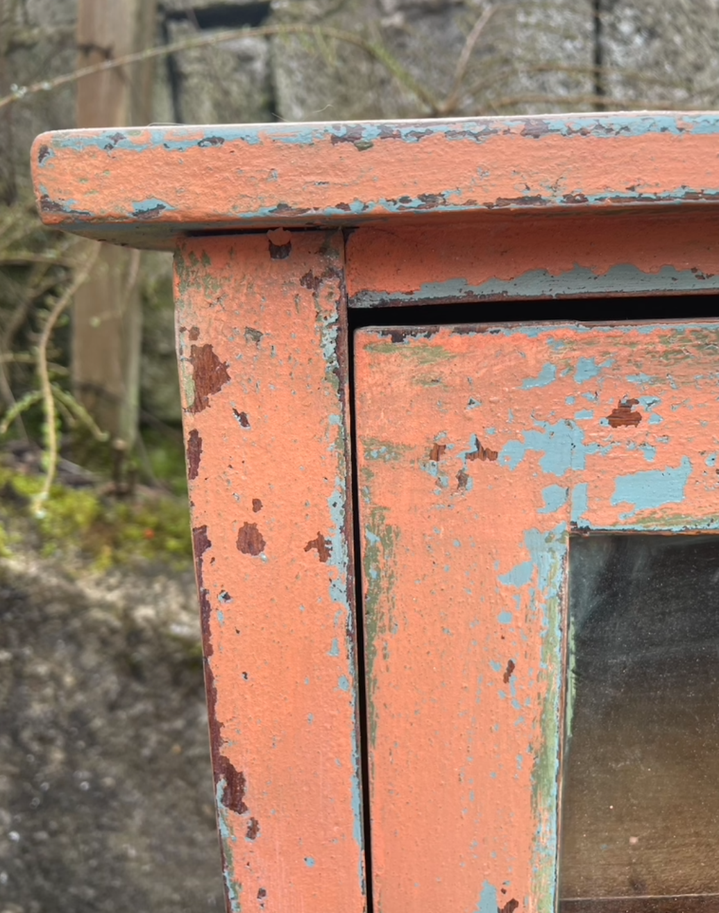 Vintage glass fronted cabinet painted in layers of traditional milk paint
