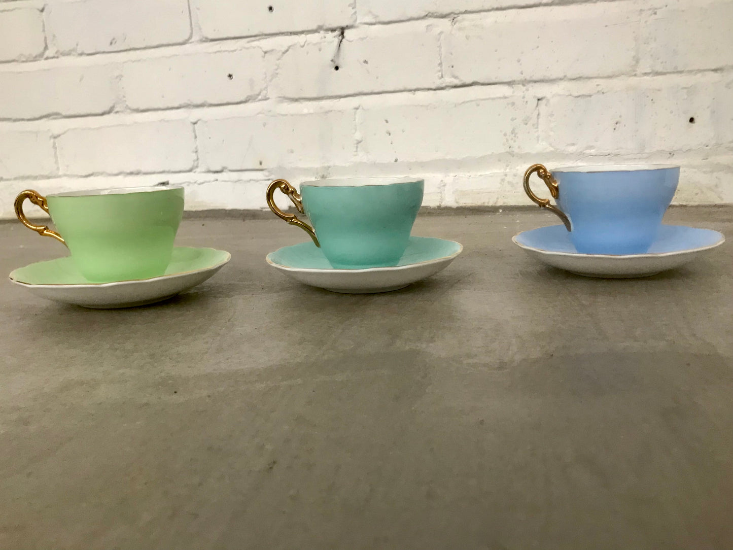 Vintage pastel and white teacups and matching sideplates