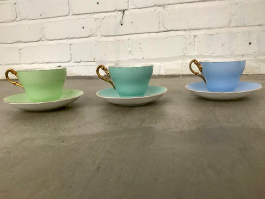 Vintage pastel and white teacups and matching sideplates