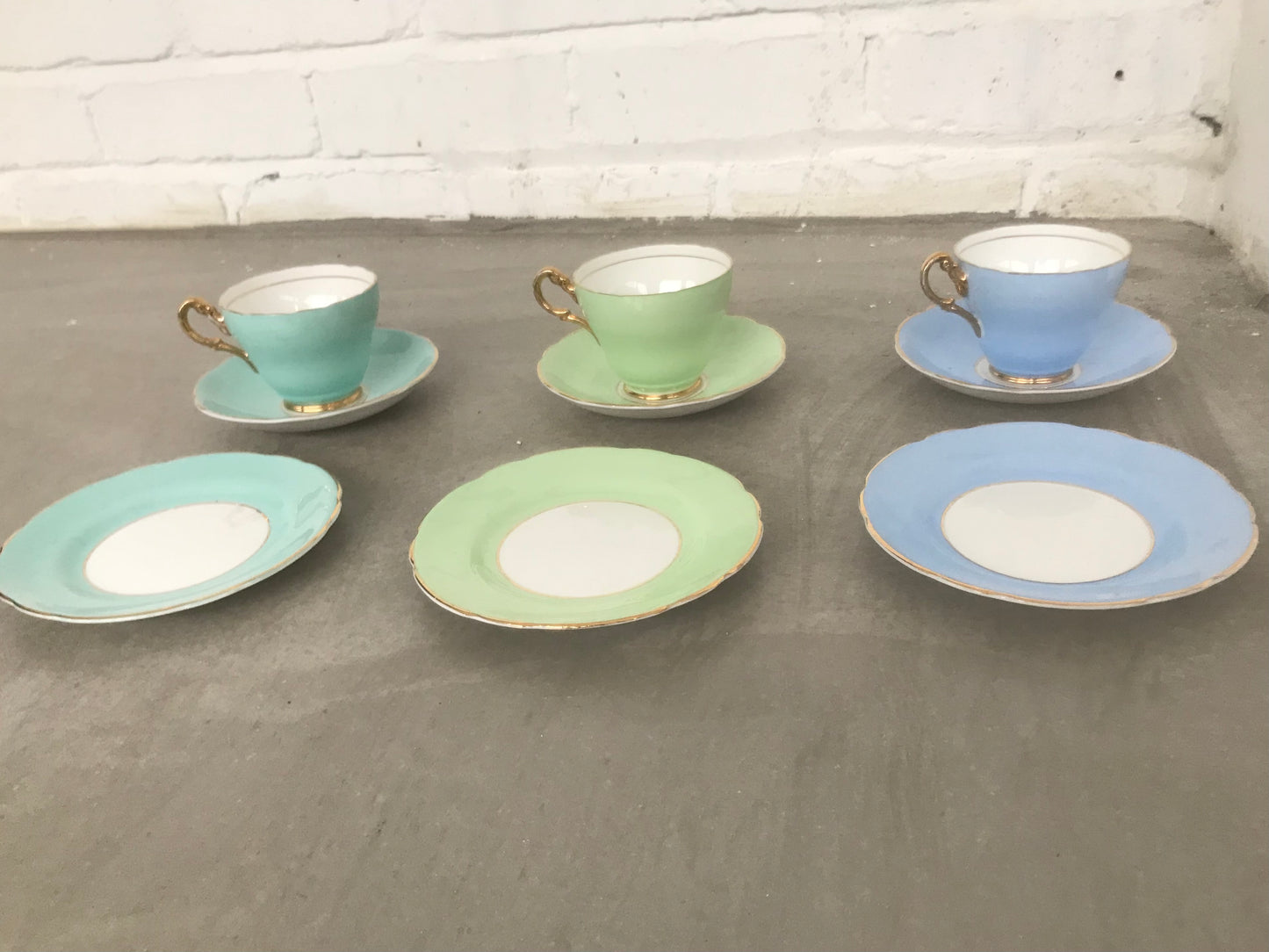 Vintage pastel and white teacups and matching sideplates