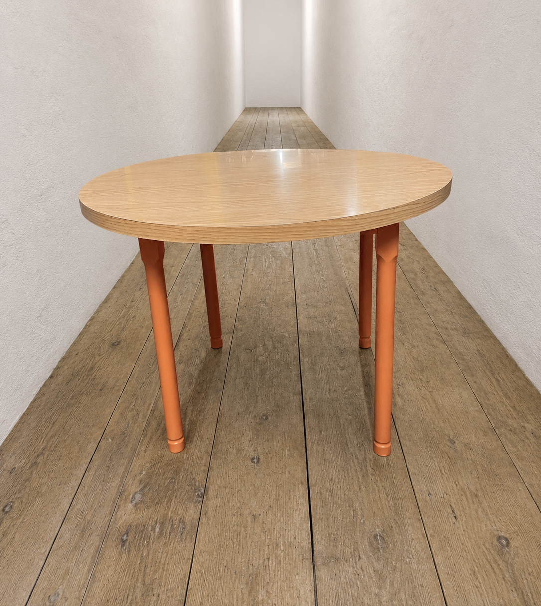 Round  veneer 1980's dining table. Legs have been painted in a rust colour