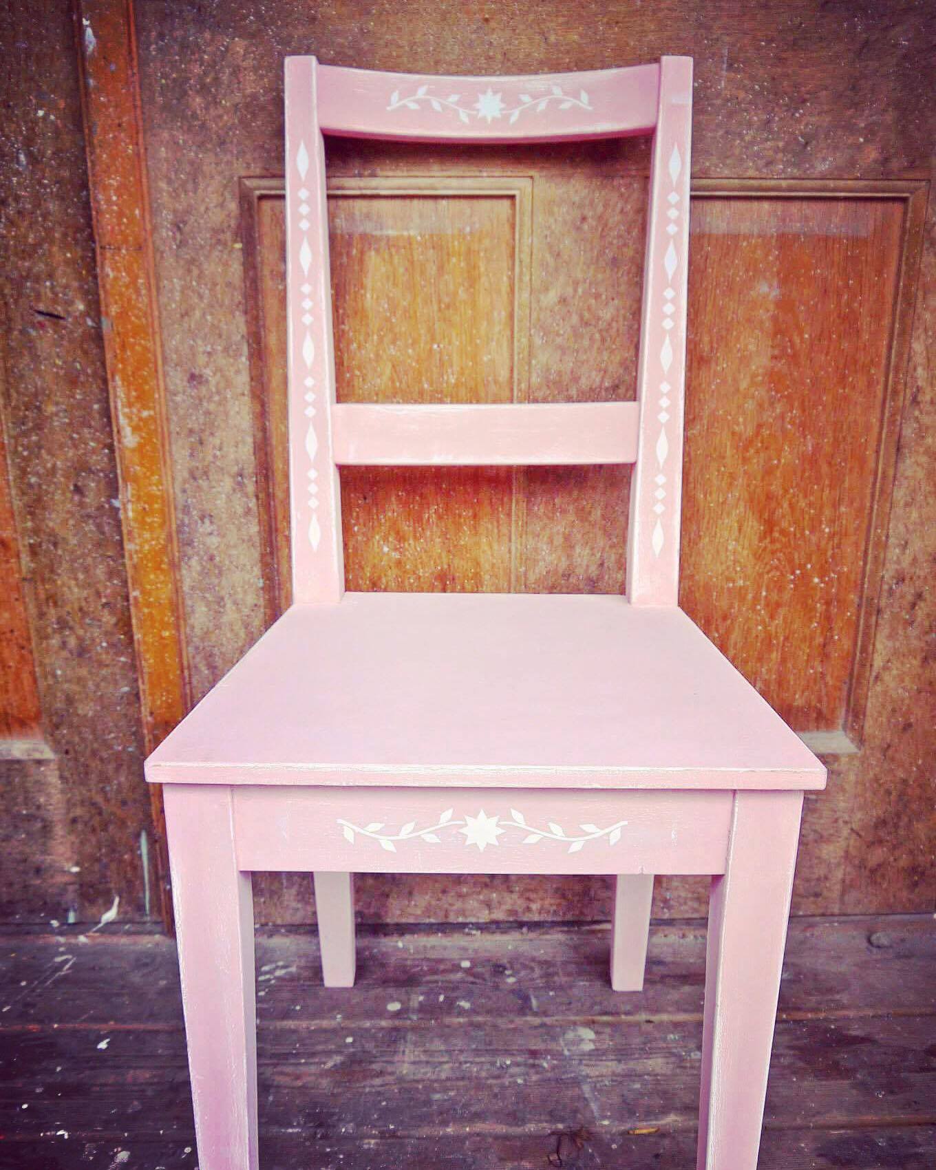 Modern chair update painted in white and pink with beautiful folk art white stencil design