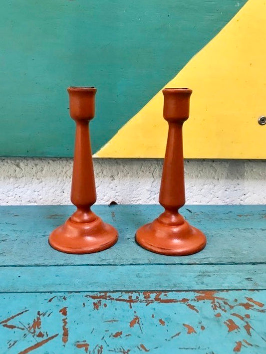 Set of two orange painted candlesticks