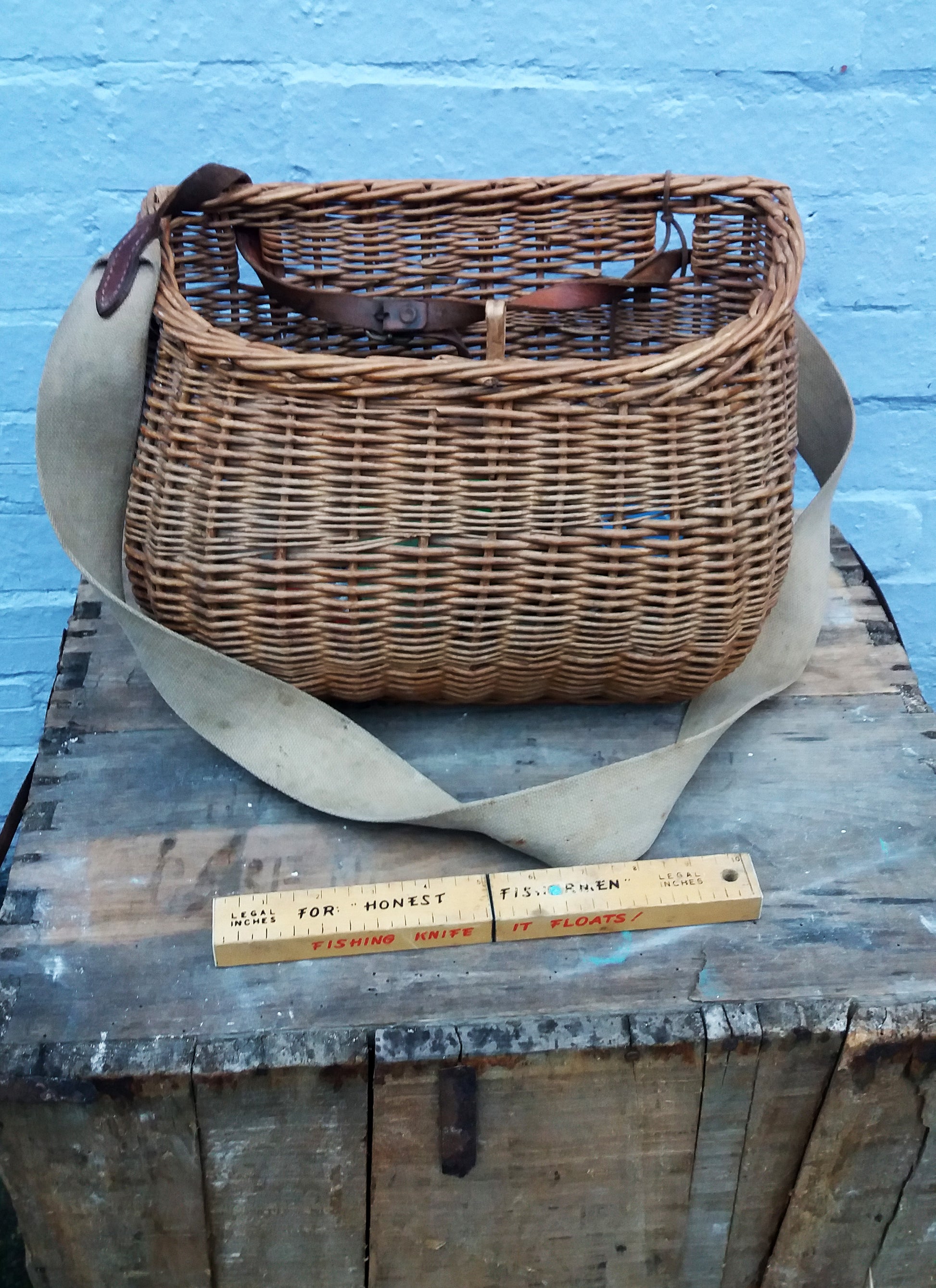 Beautiful rustic vintage wicker fisherman's basket with original strap and all its contents