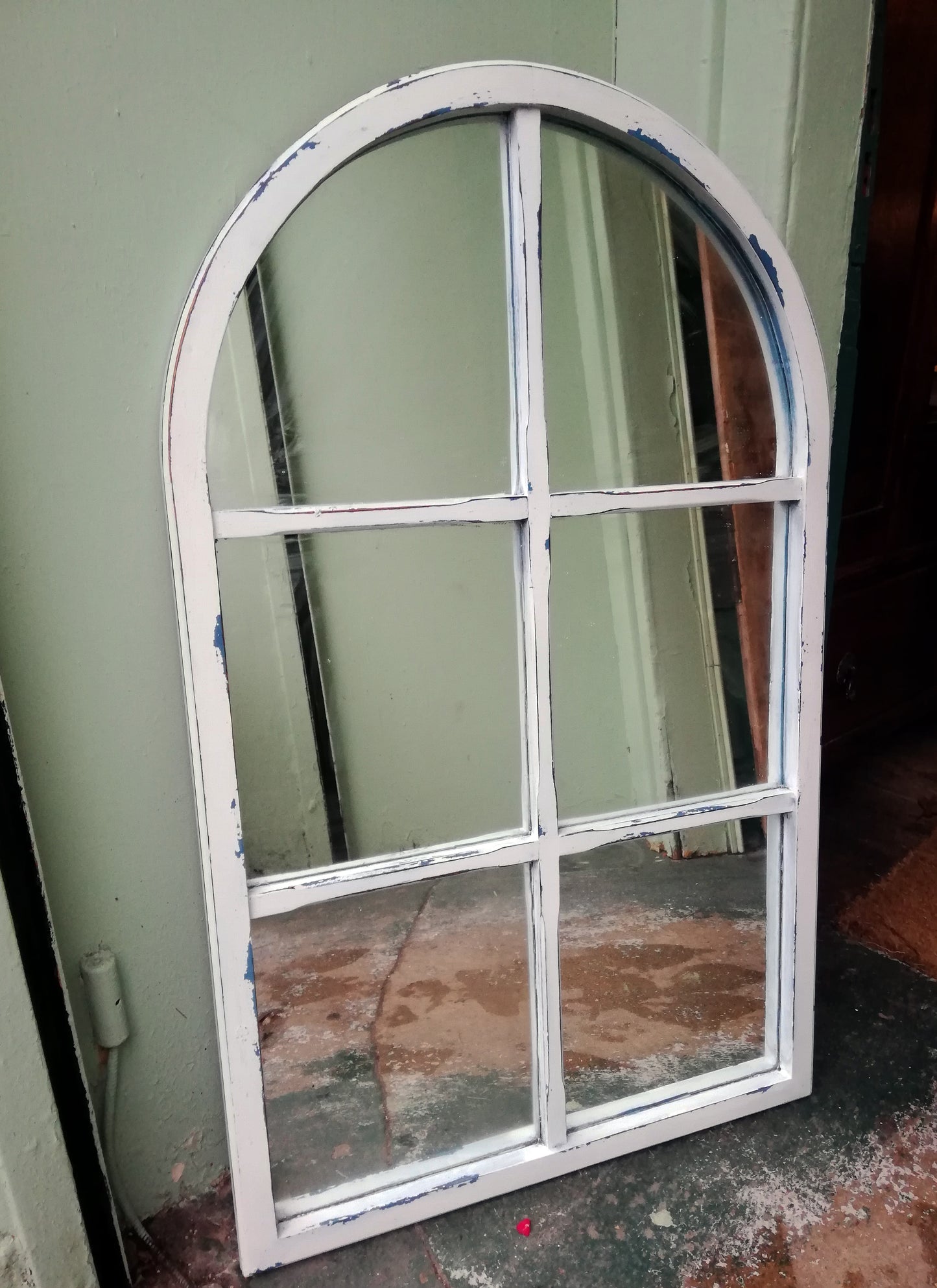 Curved window frame mirror painted in blue and white milk paint