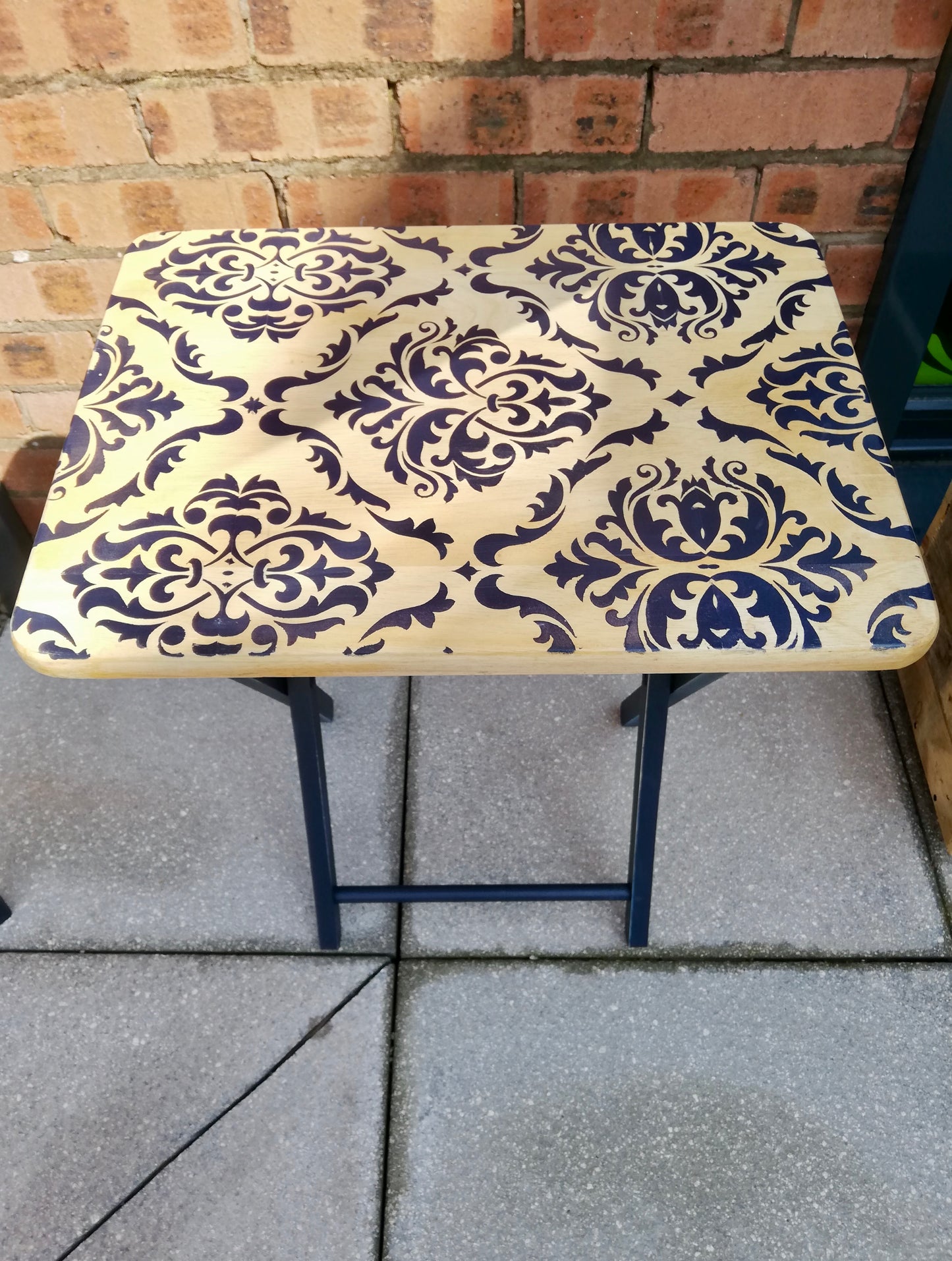 Stencilled folding side table with damask design in navy.