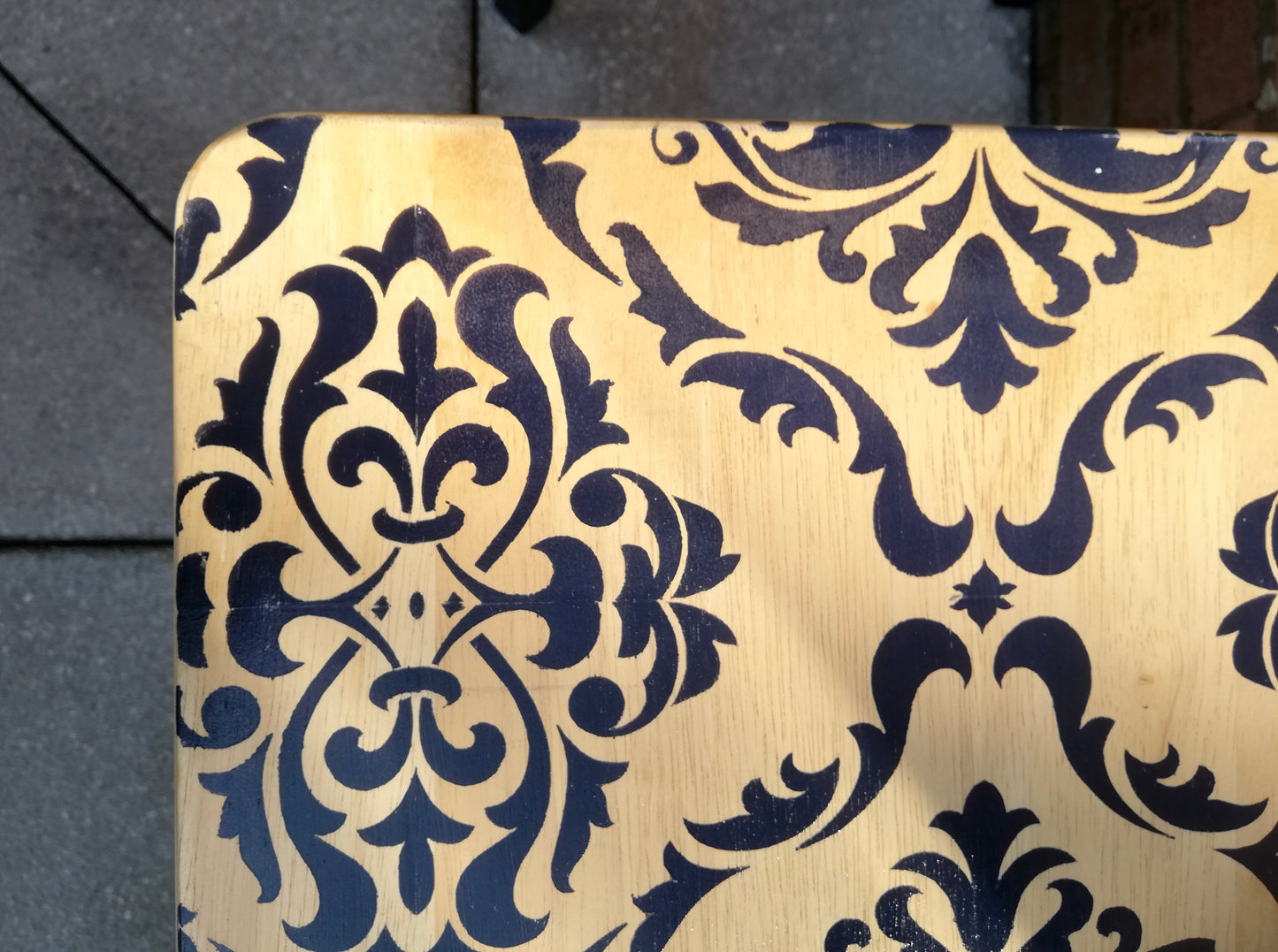 Stencilled folding side table with damask design in navy.