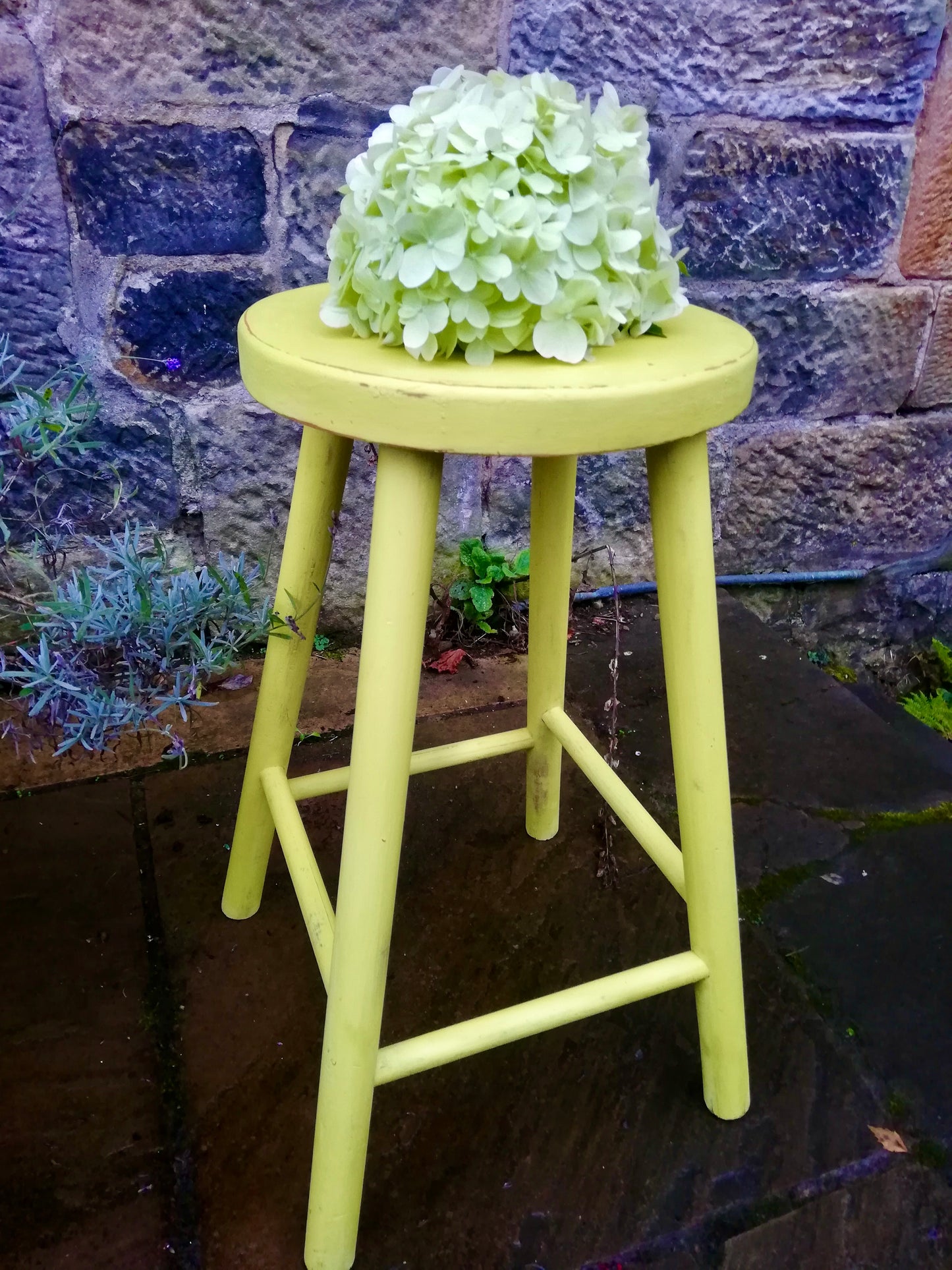 Vintage wooden stool in vibrant yellow
