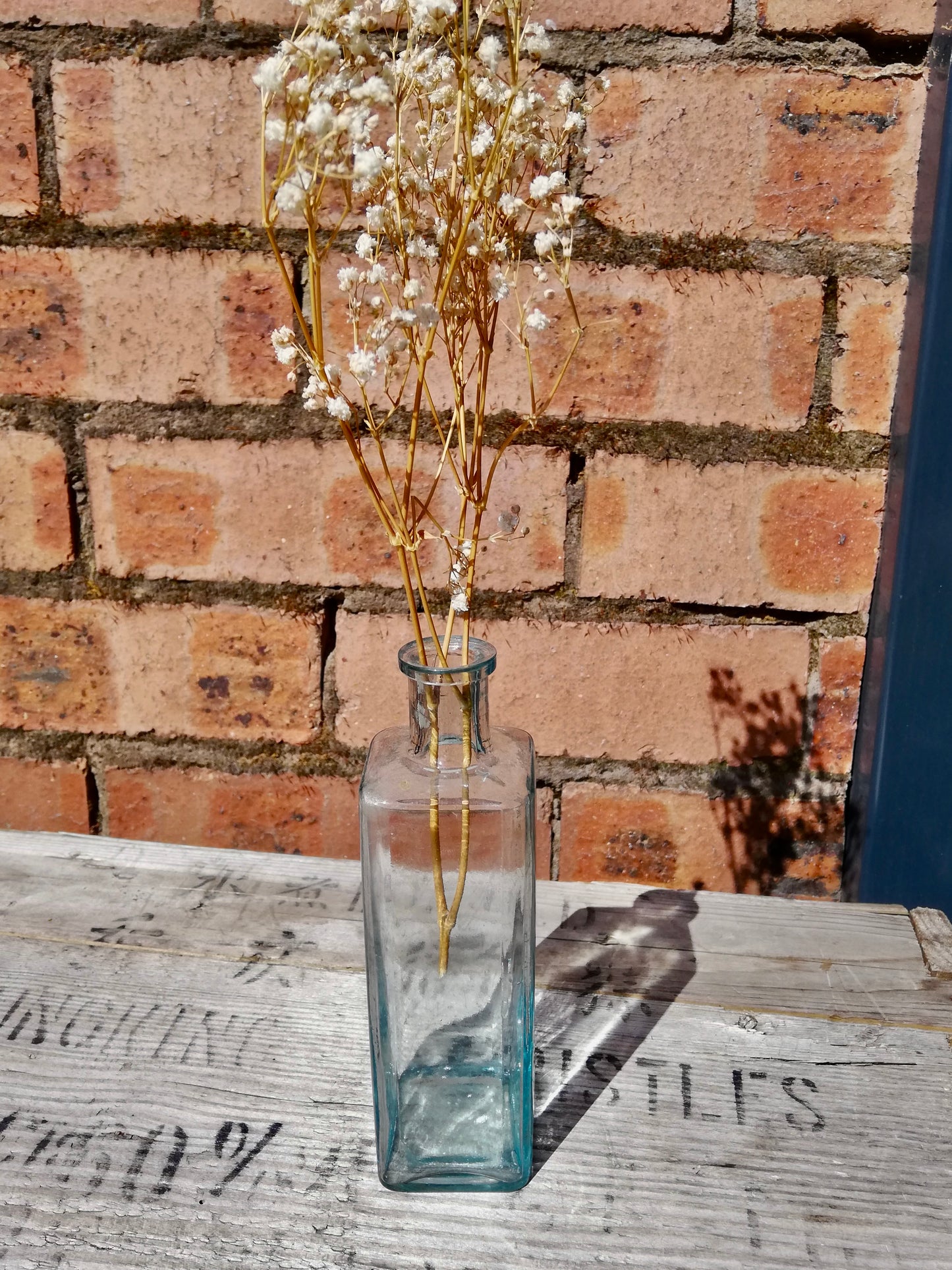 Vintage  glass bottle bud vase with dried flower stem