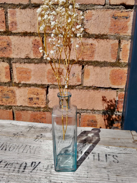 Vintage  glass bottle bud vase with dried flower stem