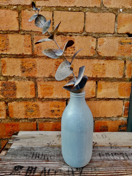 Bottle bud vase painted in layers of milk paint.