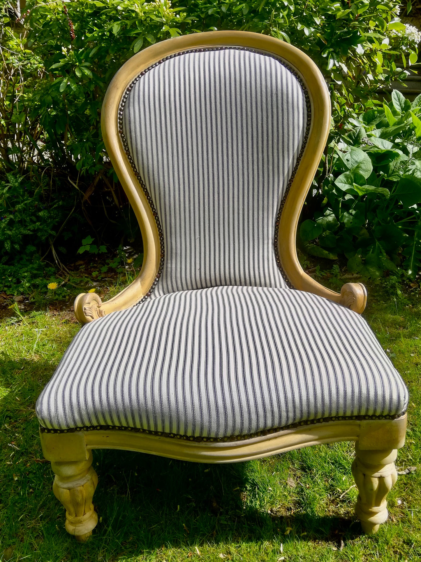 Grandmother chair painted in layers of chalk paint in grey and yellow fully reupholstered in blue ticking fabric