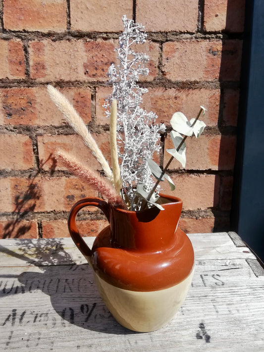 Vintage ceramic brown and cream jug with dried flower stems
