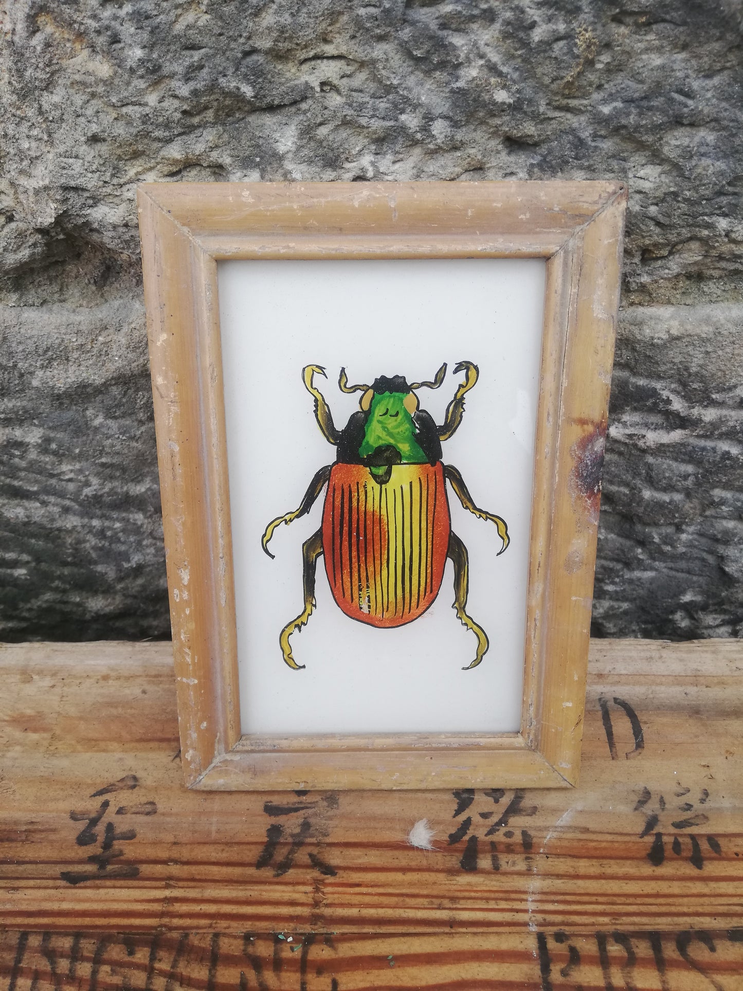 Vintage glass painting of a beetle in a beautiful original frame